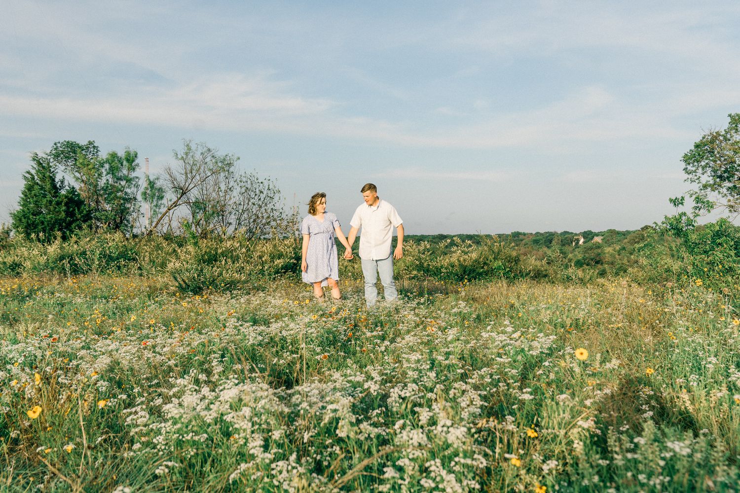 A series of romantic photos showing a couple walking through a wildflower meadow on a sunny summer day.