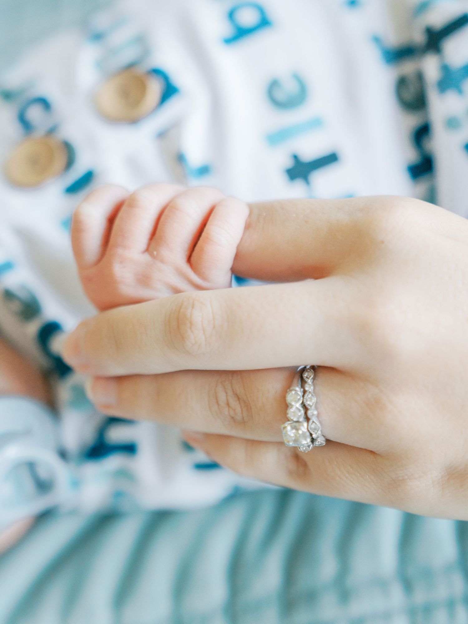 Close-up shots of a delicate diamond engagement ring on a hand against a blue and white patterned background.