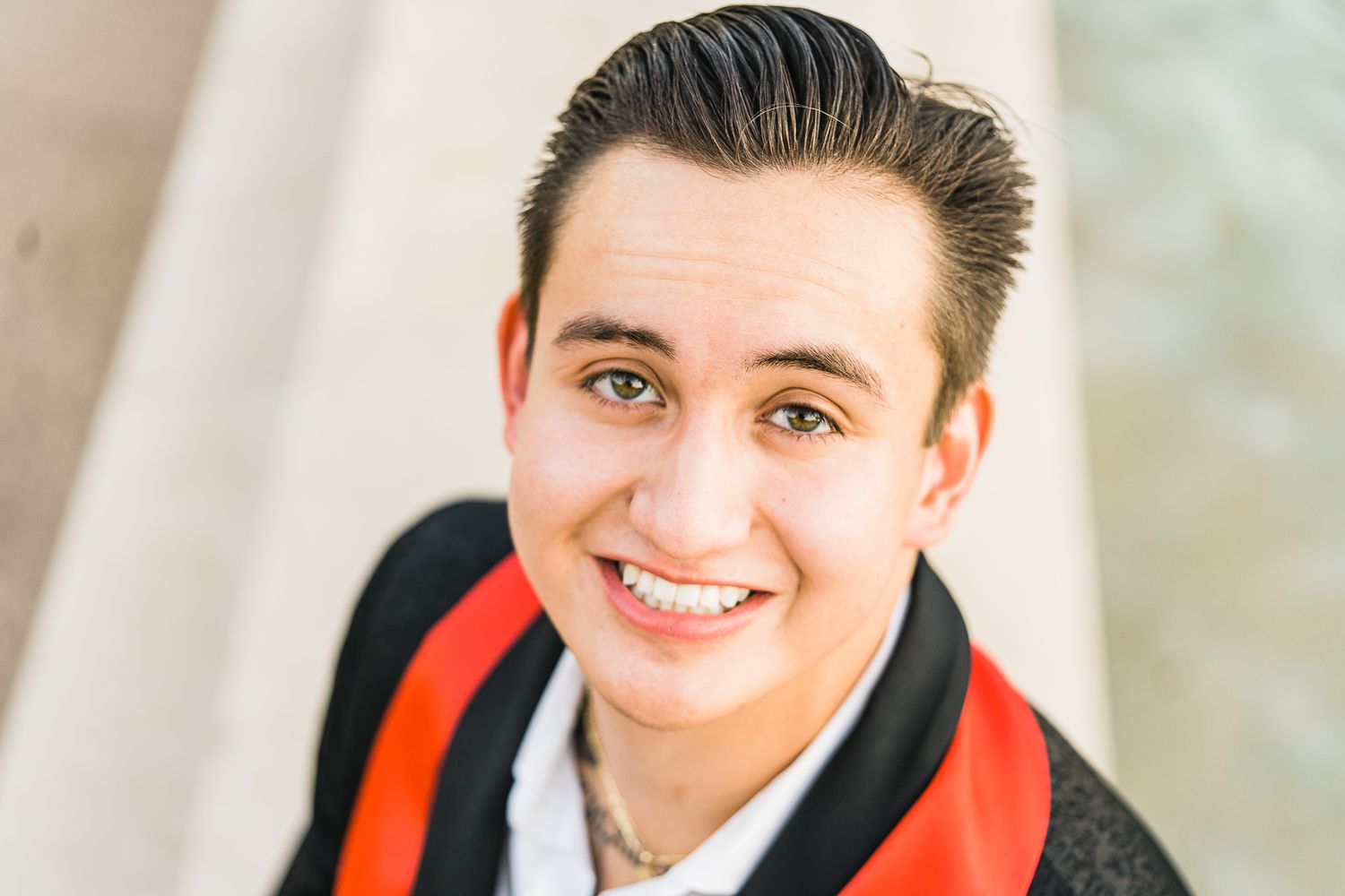 Professional headshot portraits of people wearing red and black against a light background.