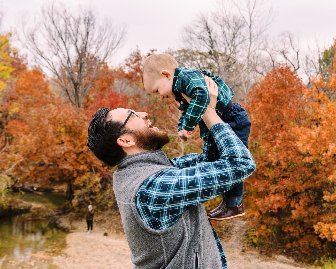 A series of fall photos showing someone in a plaid shirt walking along a scenic autumn trail with vibrant orange foliage.