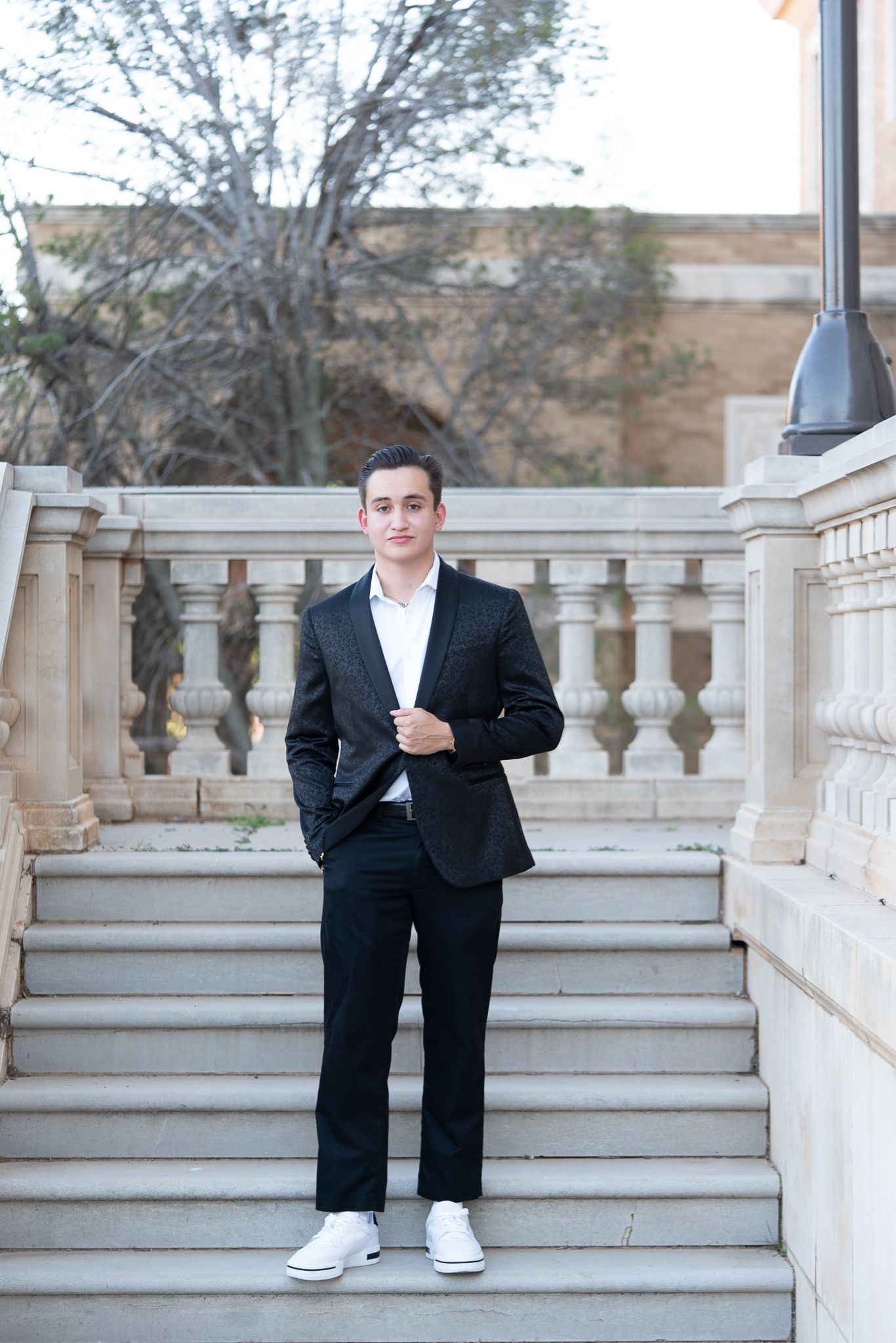 A series of photos showing someone in a black suit and white sneakers sitting on stone steps with ornate balustrades.