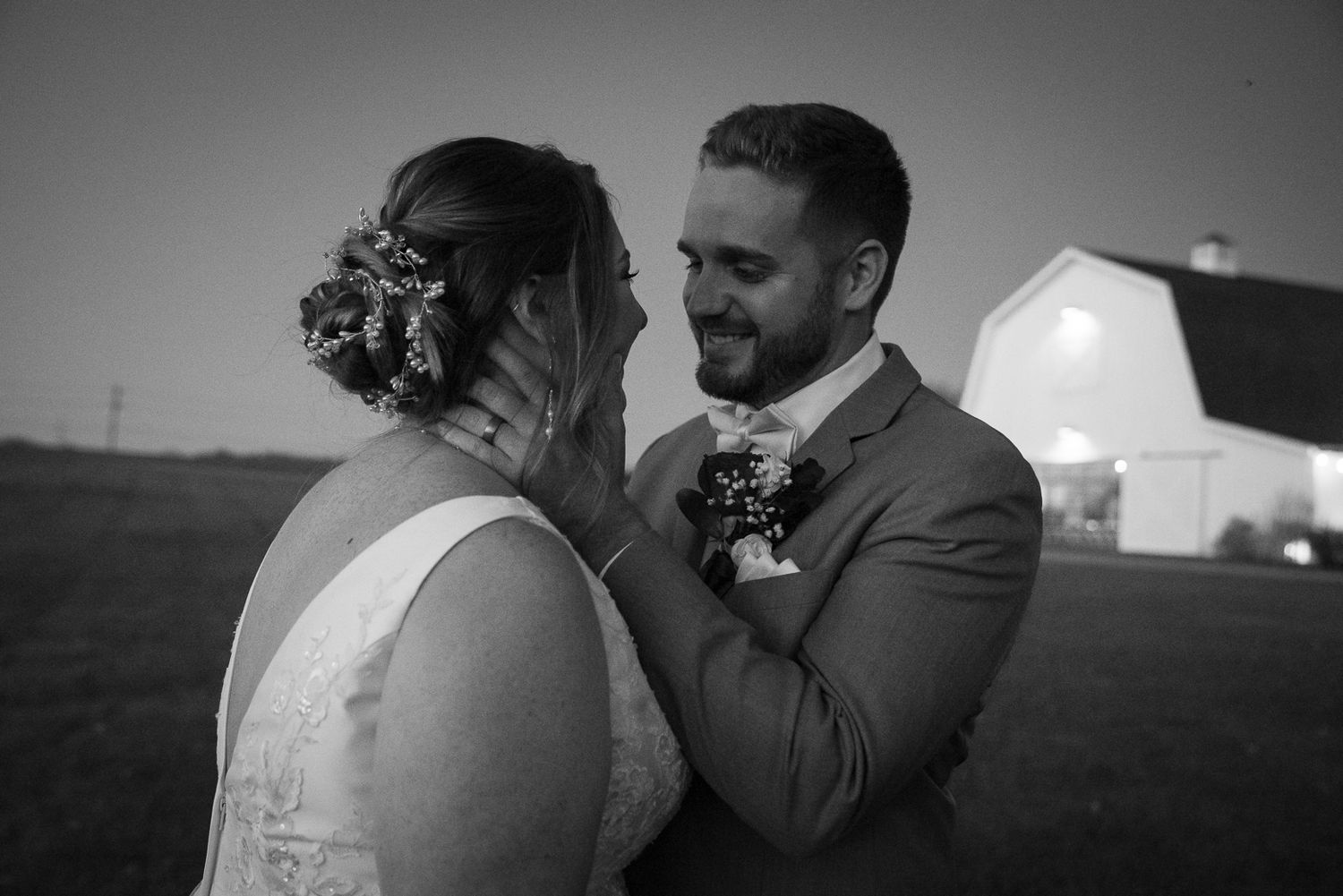A romantic black and white wedding photo series showing tender moments between a couple on their special day.