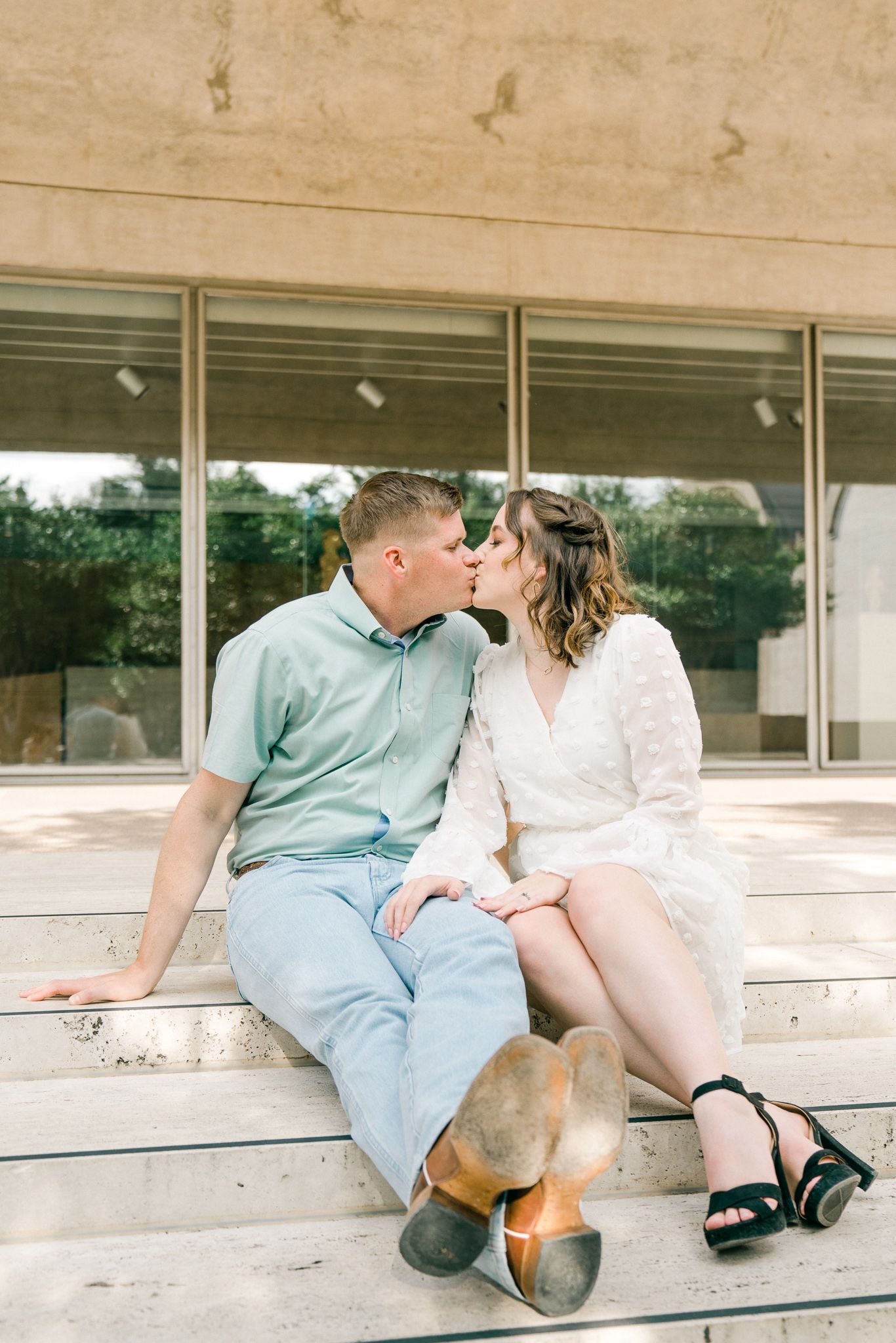 A couple sits together on concrete steps in casual summer outfits, sharing intimate moments across multiple frames.