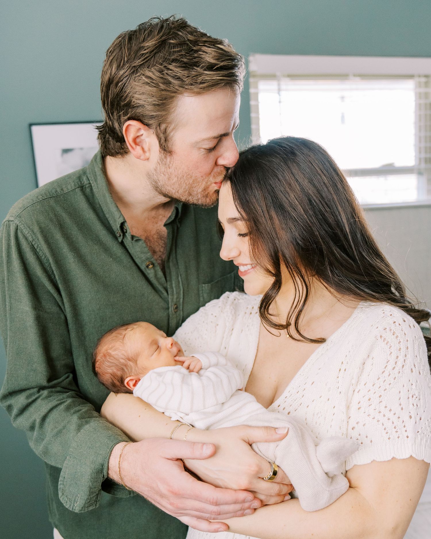 A tender family moment captured in a series of intimate photos showing parents bonding with their newborn baby.