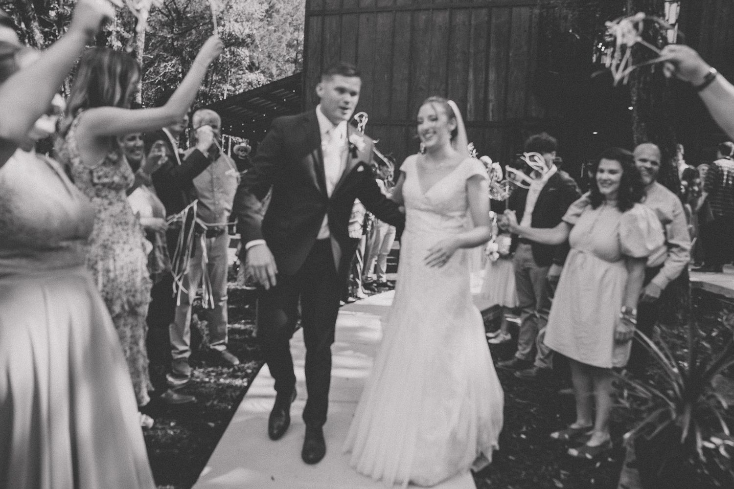 A collage of black and white wedding photographs showing couples dancing and celebrating at outdoor receptions.