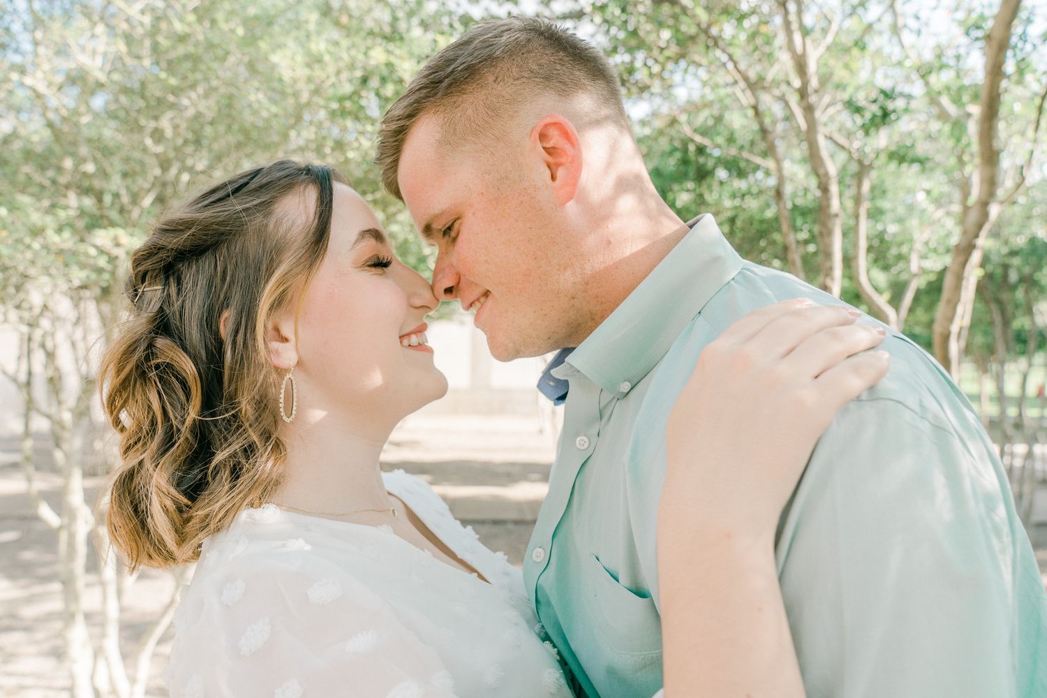 Romantic outdoor photoshoot sequence showing couple in intimate poses against a natural backdrop.