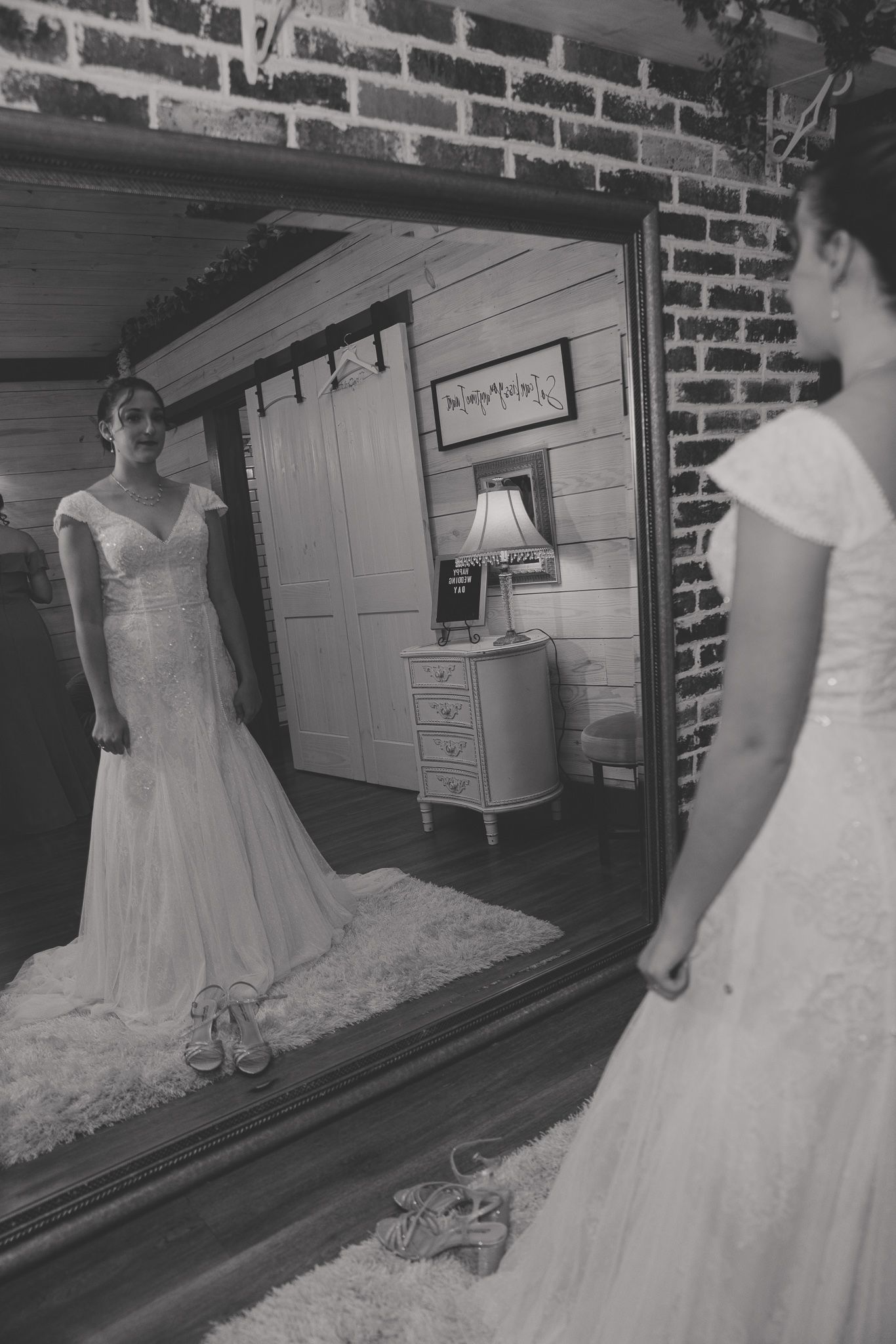 A sequence of black and white photos showing different angles of a classic white wedding dress with lace details.