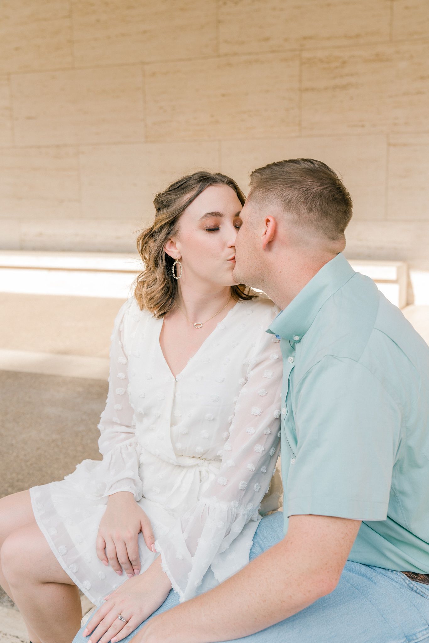 A romantic couple in white and mint clothing share tender moments in a series of intimate photos.