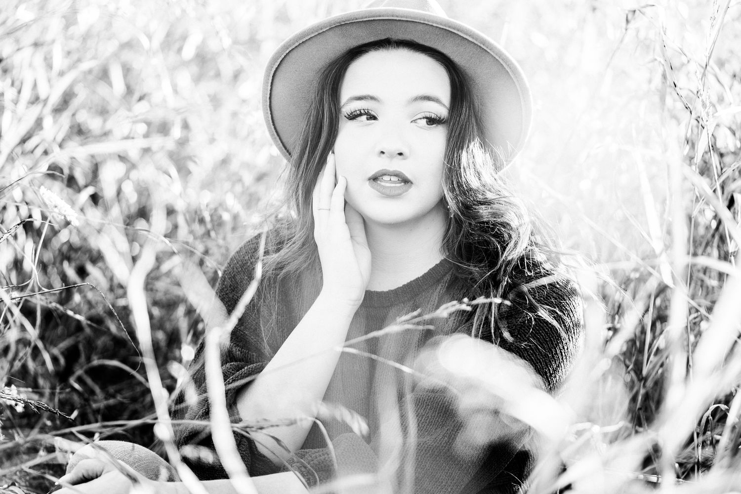 A black and white artistic portrait series showing glamorous vintage-style poses against a light floral background.