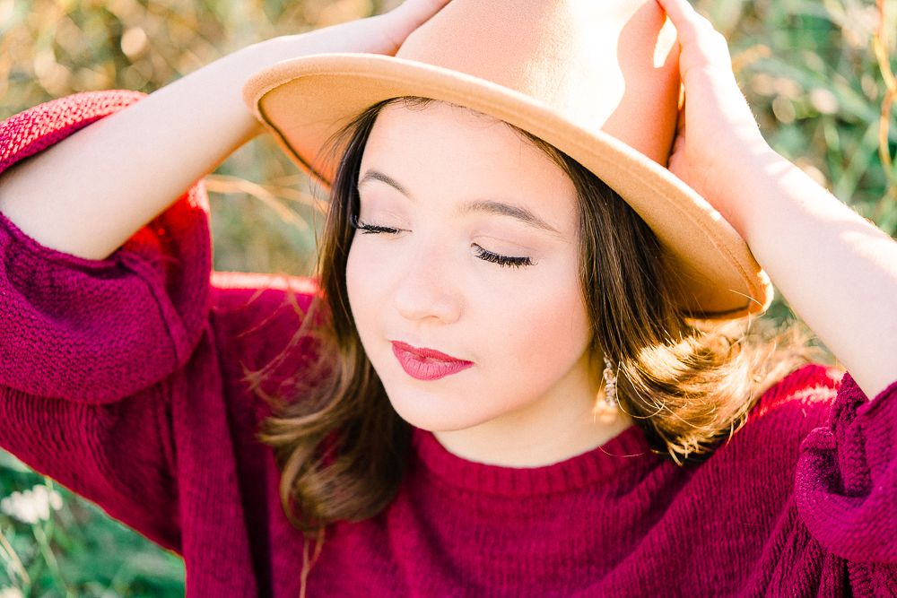 Artistic portrait series showing burgundy sweater and tan hat with natural lighting and soft expressions.