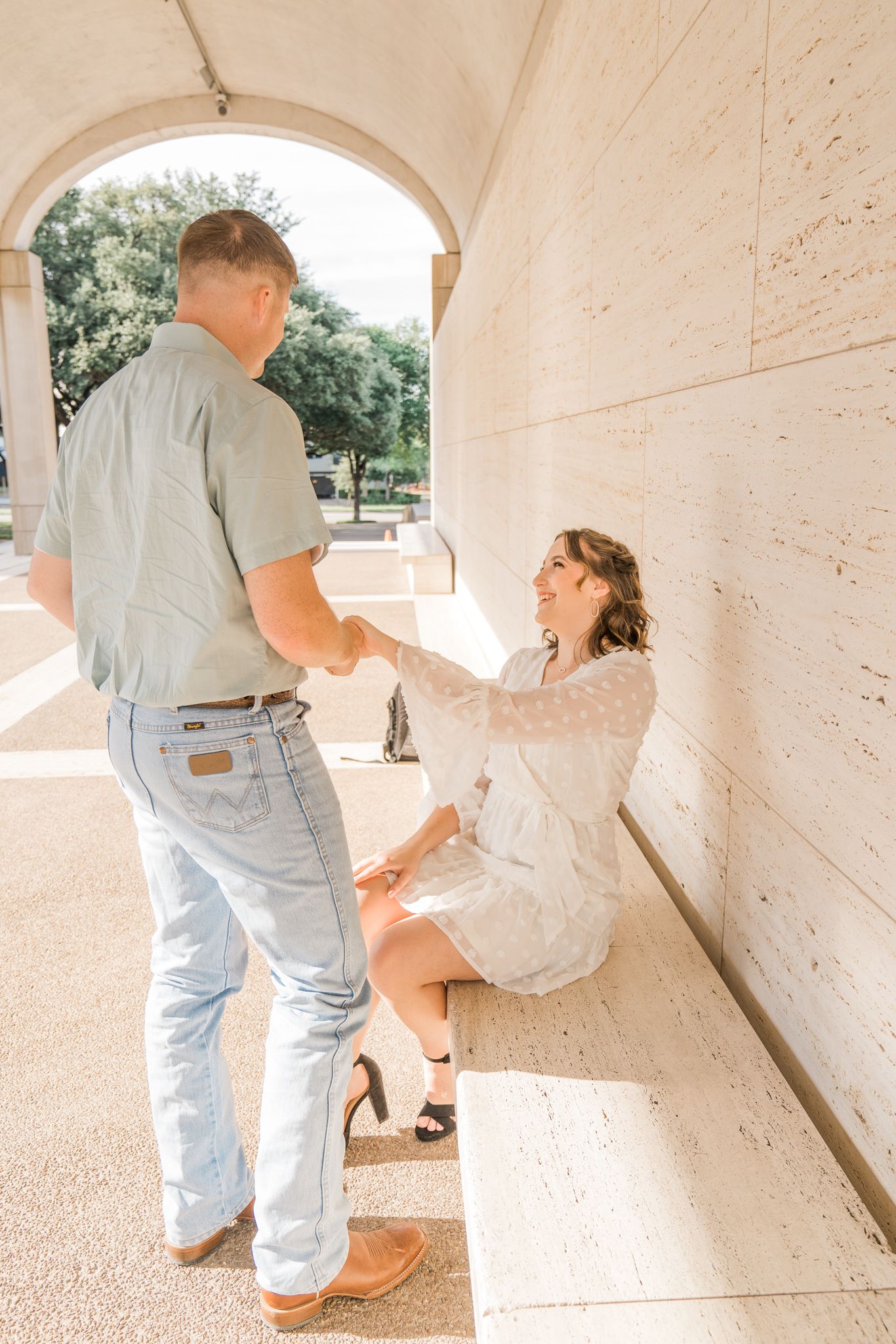 A series of connected photos showing a couple in light colored clothing sitting and interacting under an arched walkway.