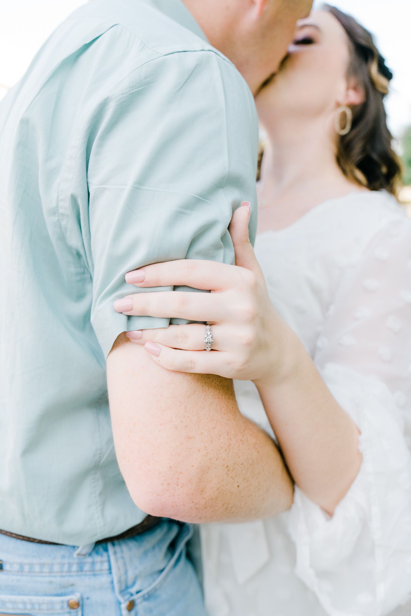 Close-up shots showing tender moments and gentle embraces in soft natural lighting.