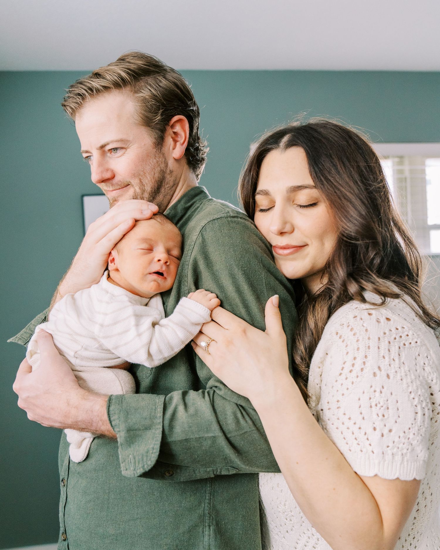 A tender family moment captured in a series of intimate photos showing parents embracing their newborn baby.