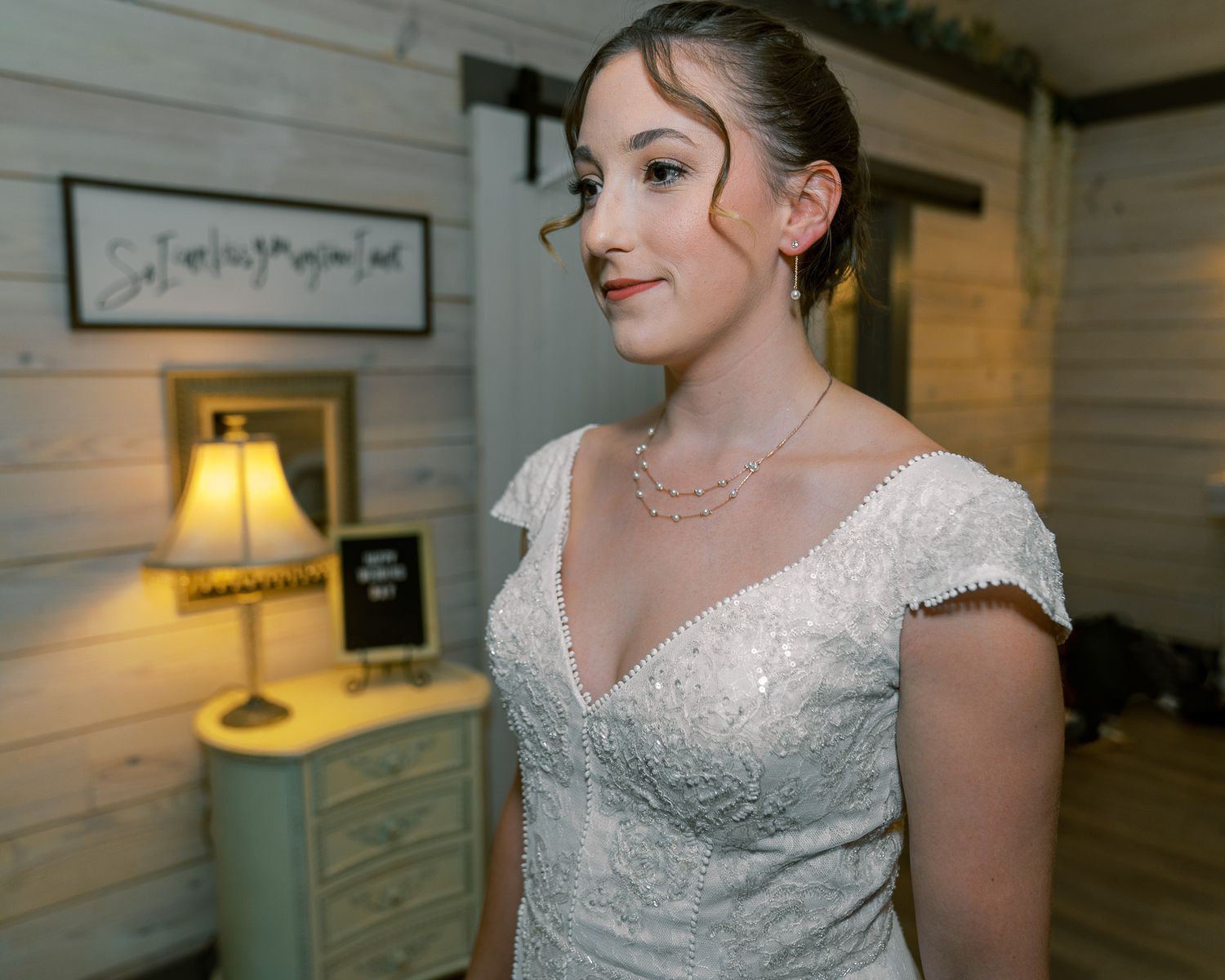 A series of photos showing someone in an elegant white beaded wedding dress in an indoor setting with wood paneled walls.