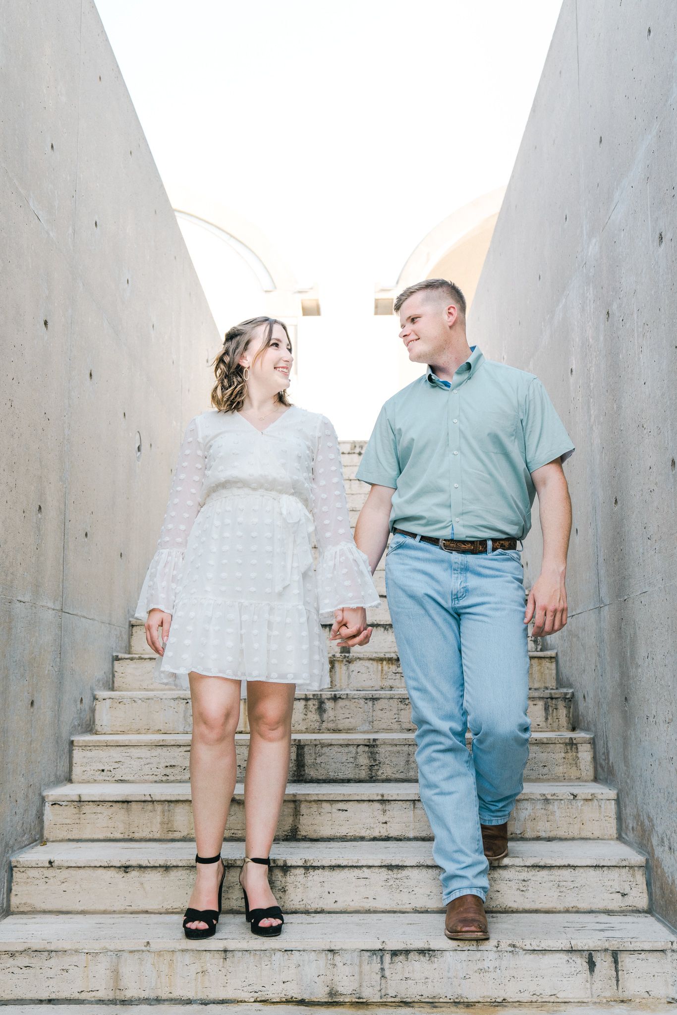 Couple walking up concrete steps together in a playful sequence of photos.