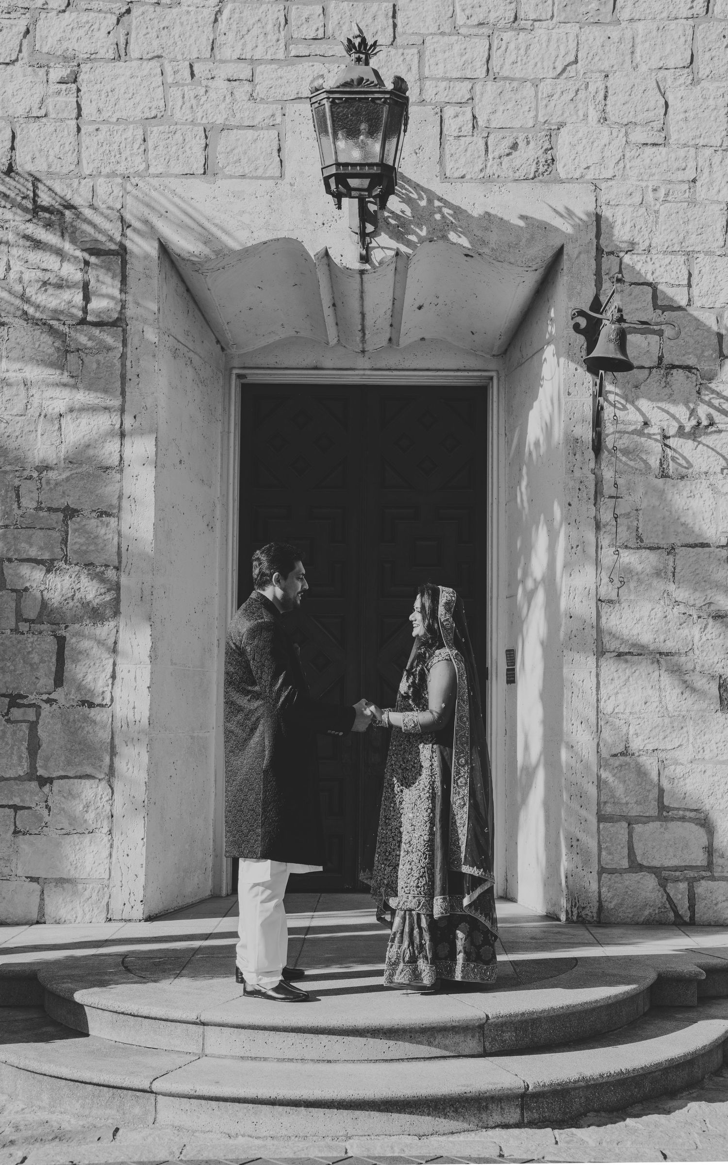 Black and white sequence showing people entering through a stone doorway with curved steps.