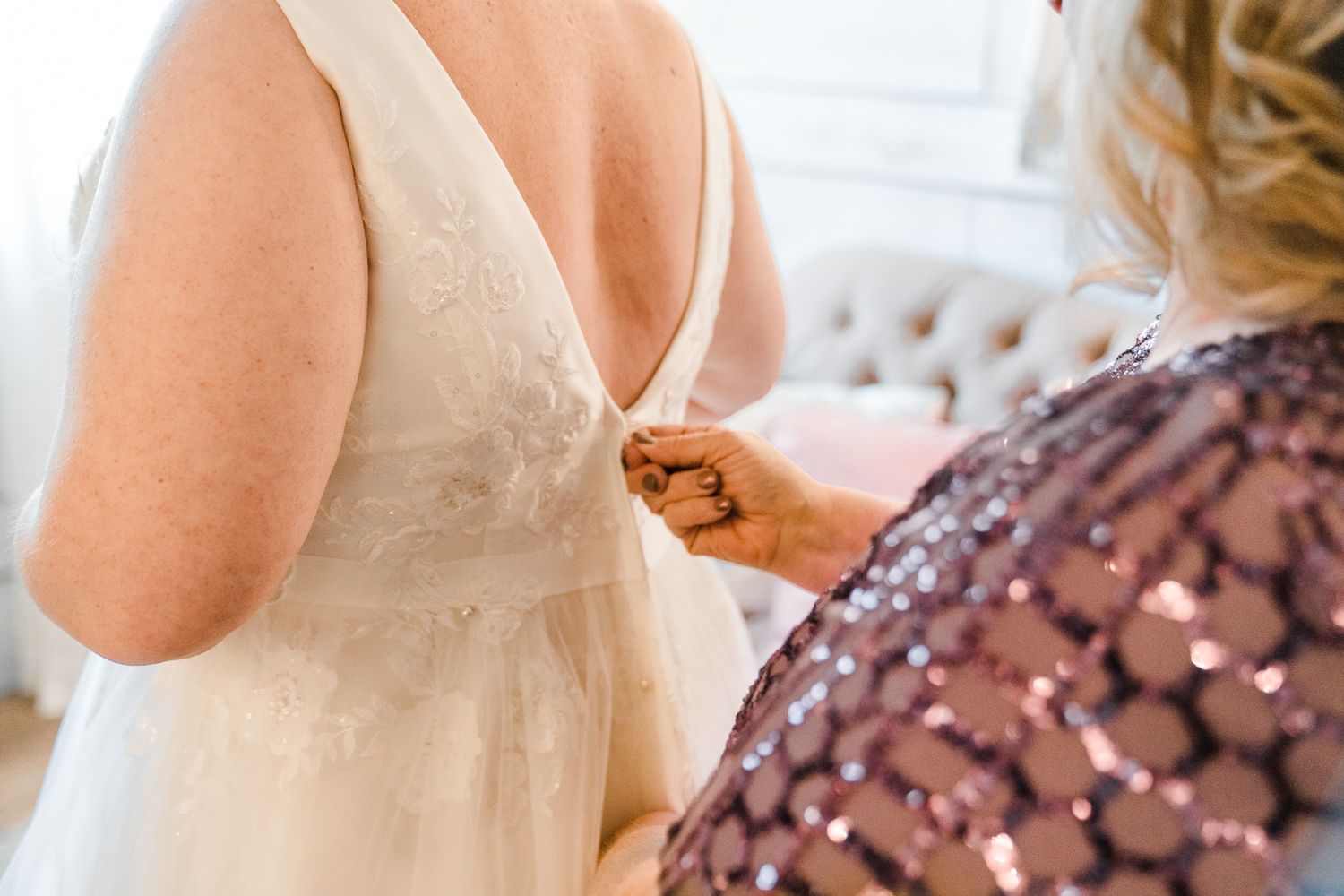 Wedding party members in formal attire gathered during pre-ceremony preparations.