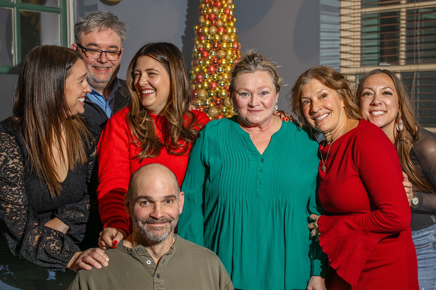 A group of people smiling and posing together at what appears to be a holiday gathering.