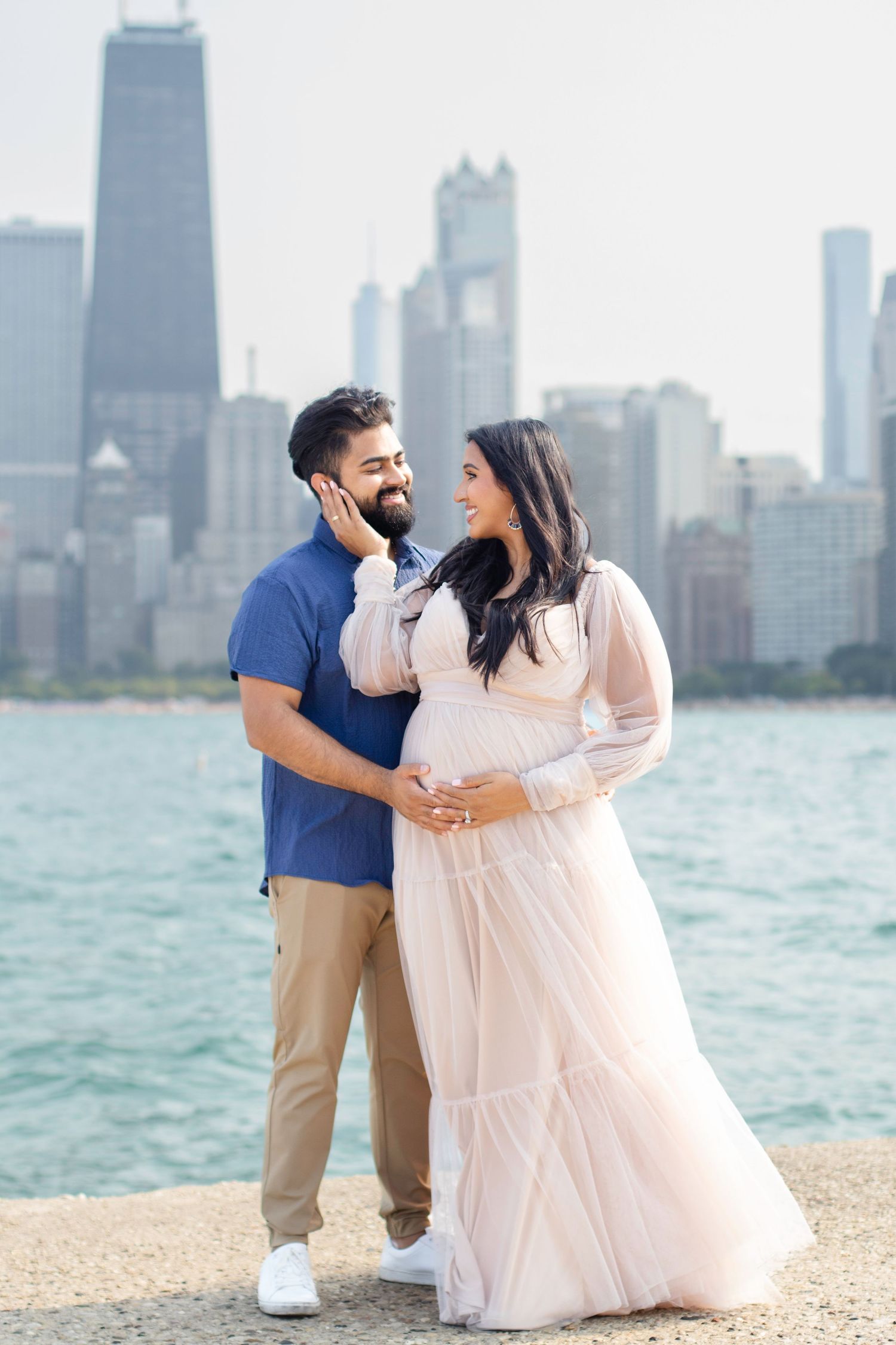 Romantic maternity photo session with Chicago's iconic skyline providing a stunning backdrop.