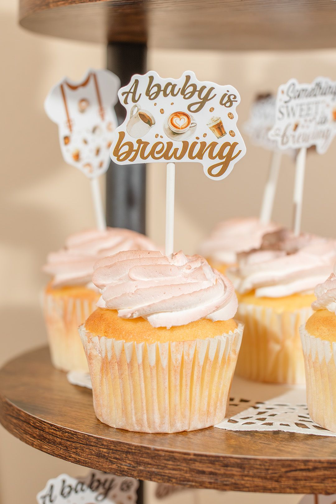 Baby shower cupcakes with pink frosting and 