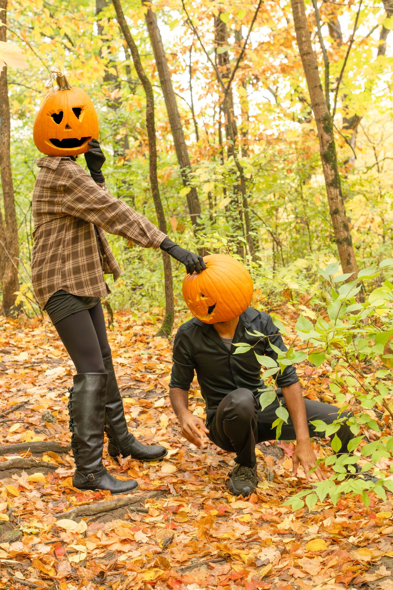 A sequence of four autumn photos showing someone wearing a pumpkin head while crouching in fallen leaves.