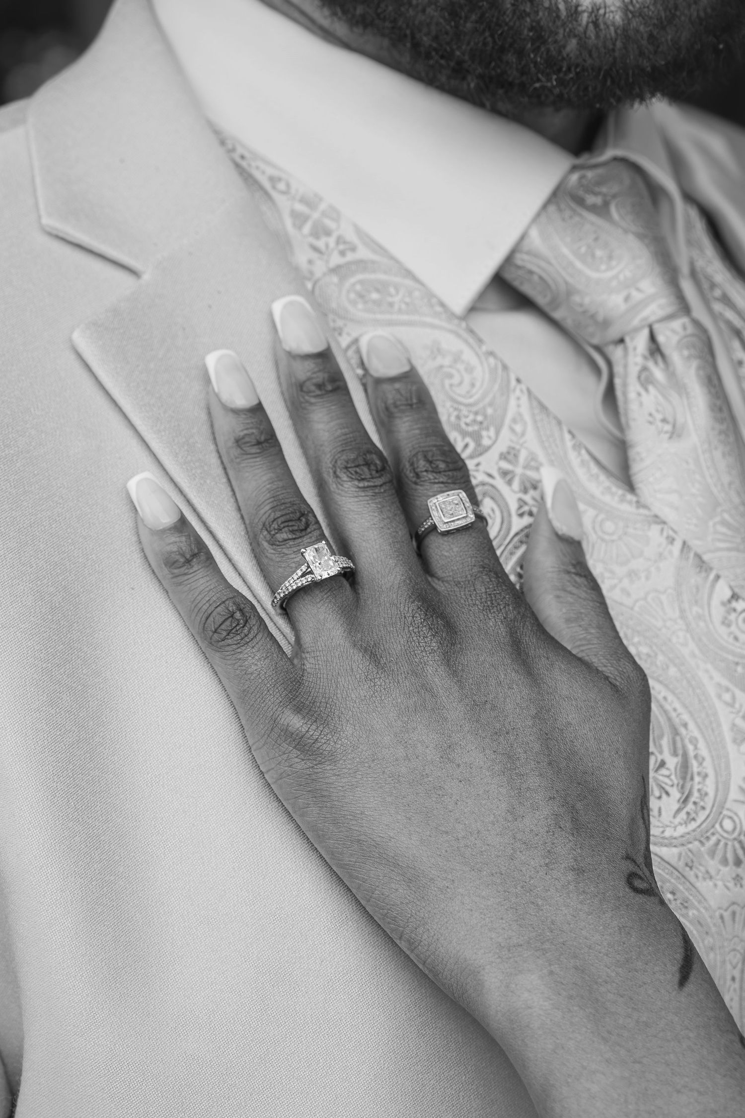 Close-up shots of hands wearing elegant diamond engagement rings and white manicured nails.
