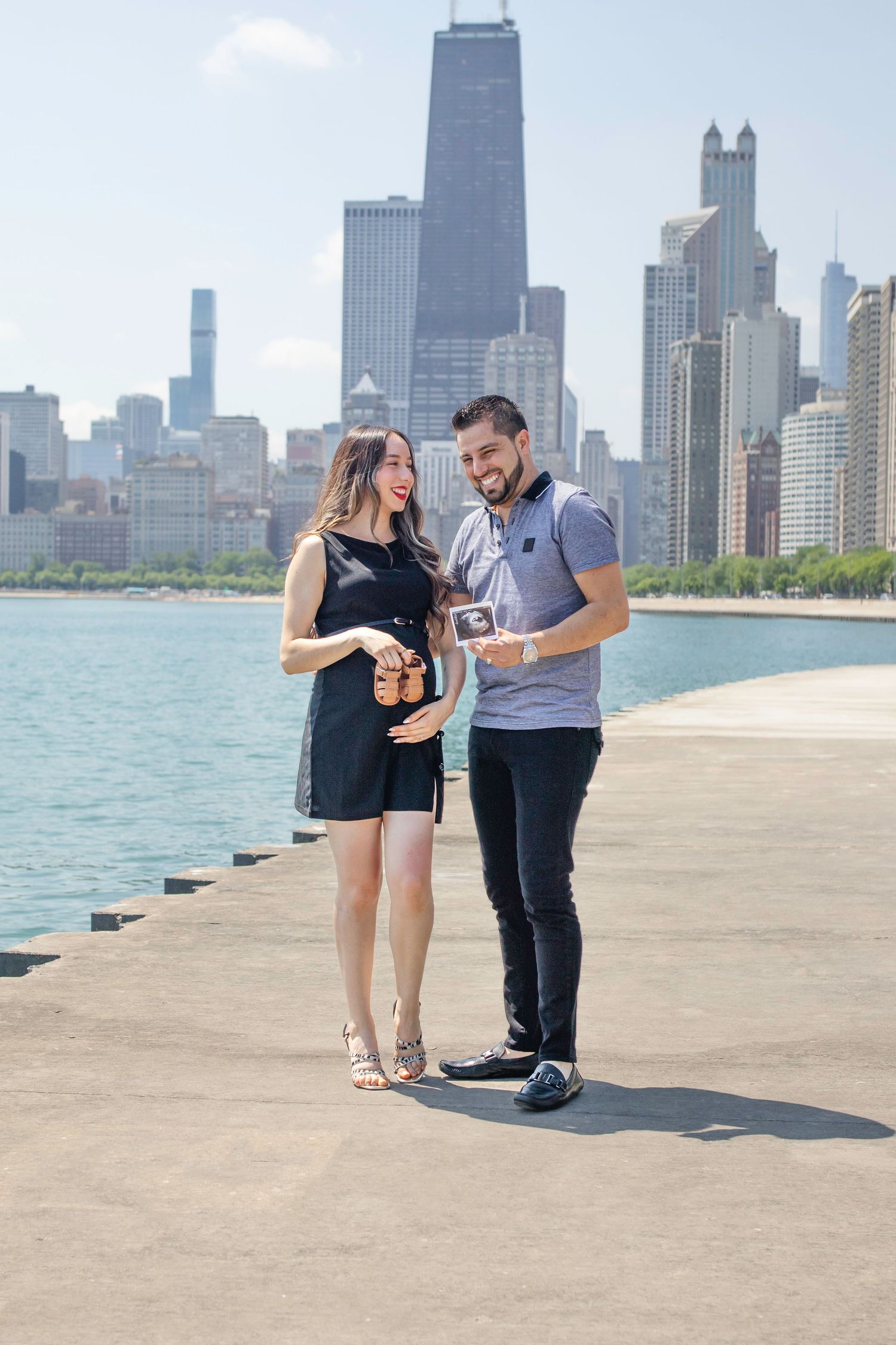 People looking at a breathtaking skyline along Lake Michigan on Chicago's iconic lakefront path on a sunny summer day.