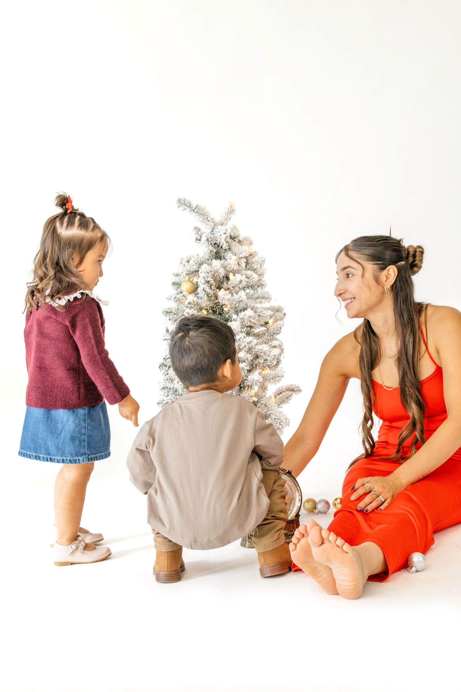 A series of artistic photos showing a person in a red dress and others in casual attire posing with dried flowers.