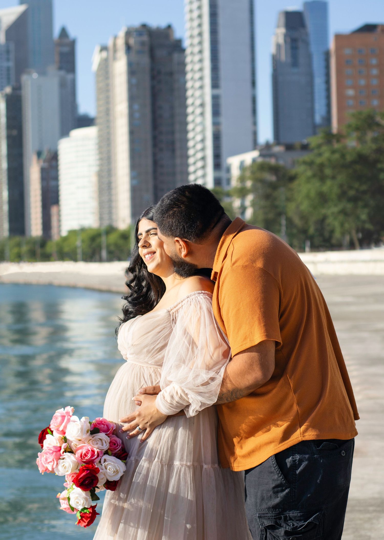 A romantic maternity photoshoot by Lake Michigan with the Chicago skyline in the background.