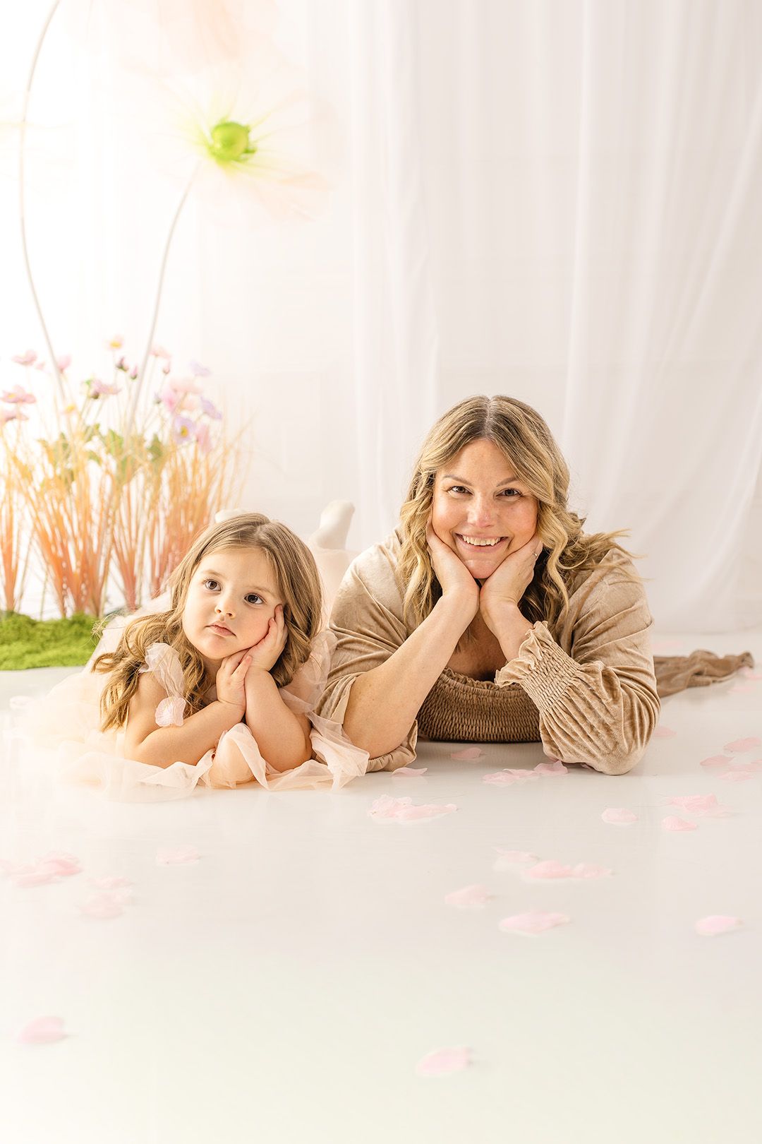 Portrait series showing playful poses on white backdrop with soft lighting and floral accents.