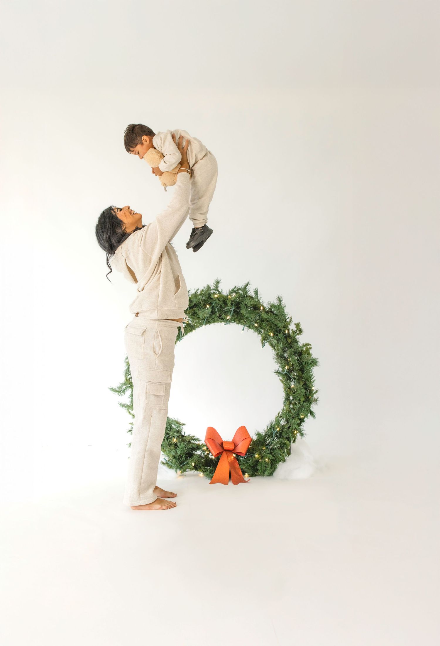 Three connected photos show a person in white clothing interacting with a green holiday wreath against a white backdrop.