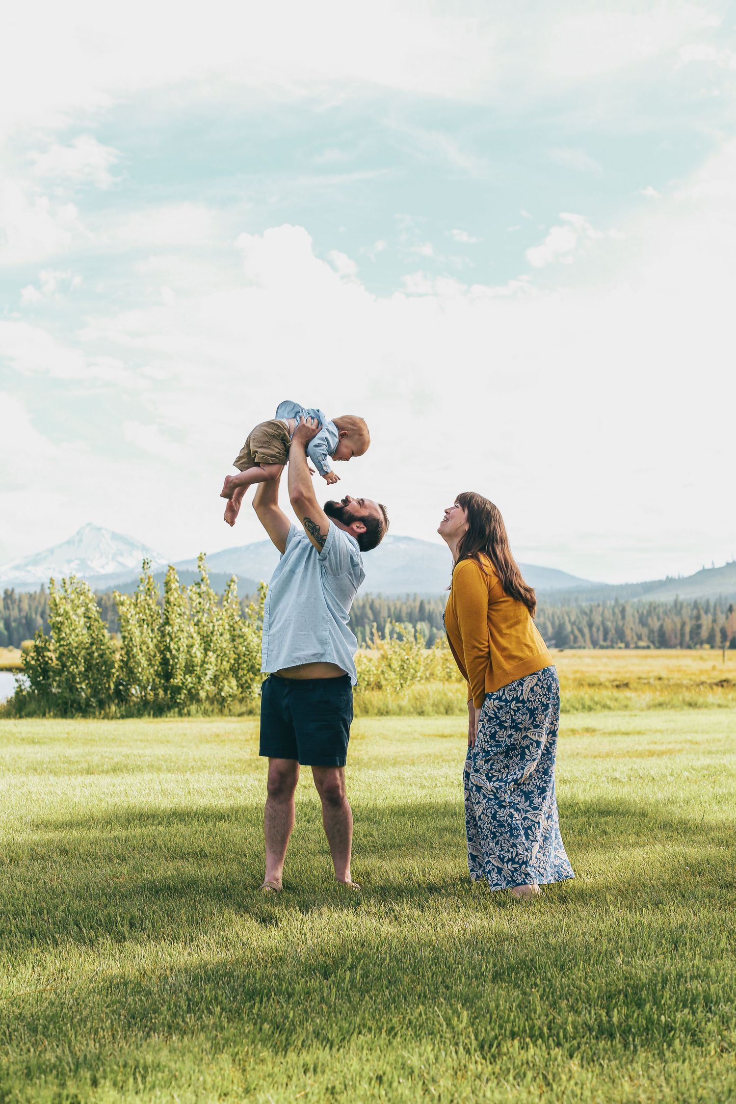 dad-holding-son-in-air-mom-smiling-bend-oregon