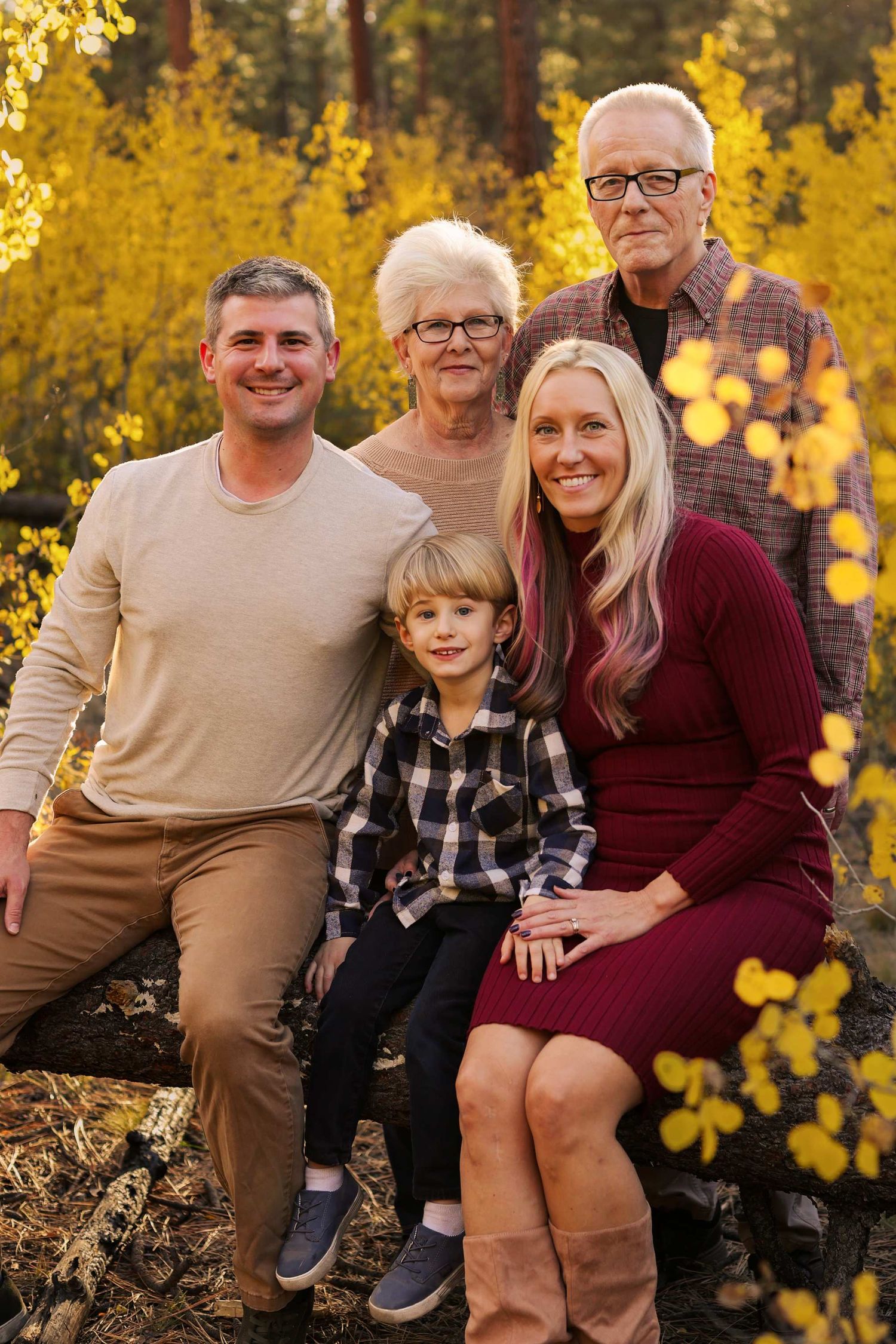 Family portrait series with coordinated burgundy and beige outfits against golden fall foliage in outdoor setting.