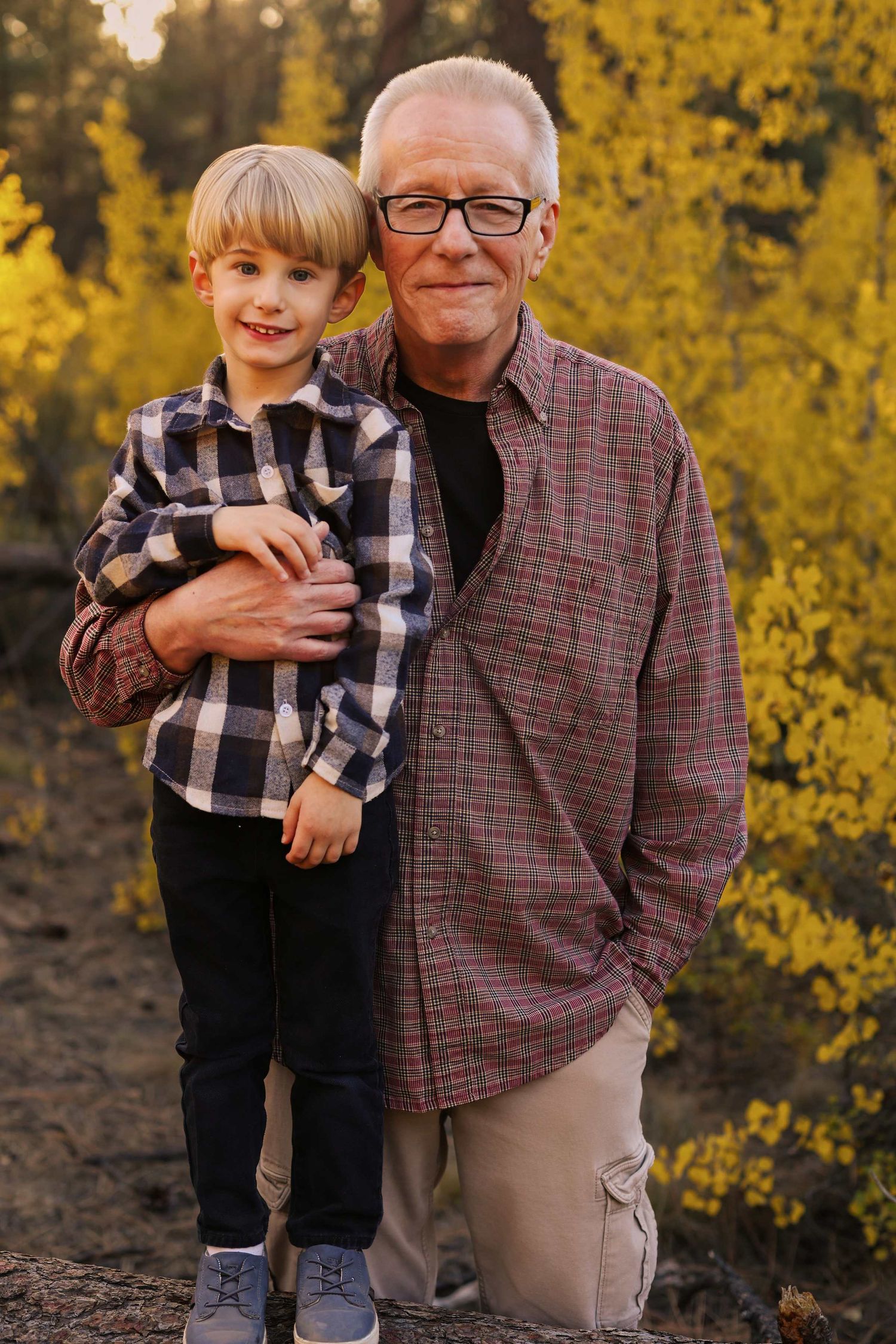A series of outdoor portraits against yellow fall foliage showing heartwarming family moments.