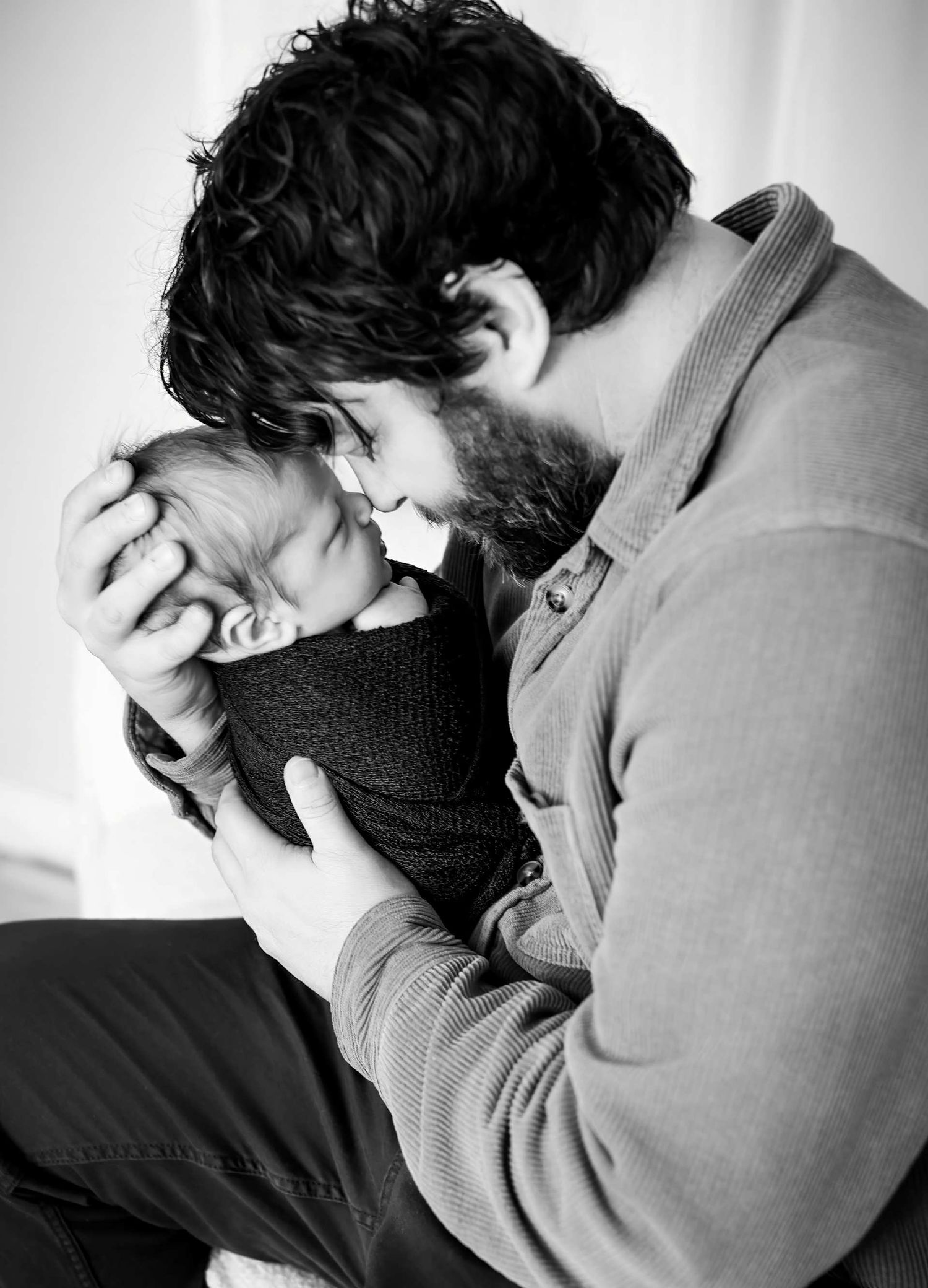 Black and white portrait series showing person in distress holding their head.