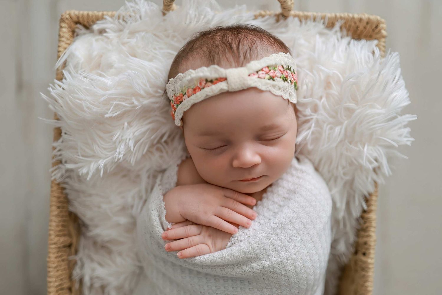 Series of newborn portraits with baby wrapped in white textured fabric and delicate lace headband.