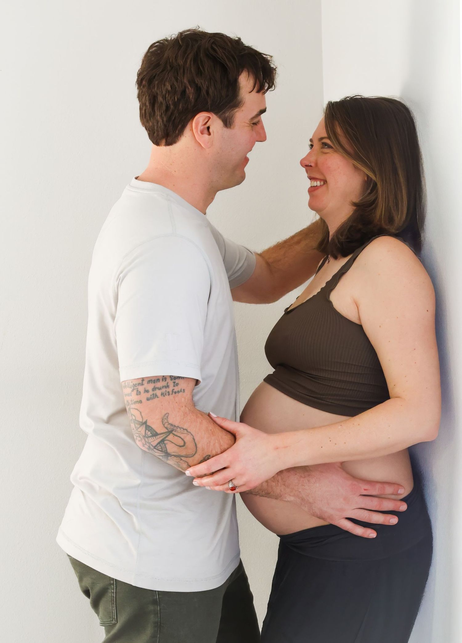 Four sequential images show a couple practicing dance steps together against a white wall. Redmond Oregon Studio