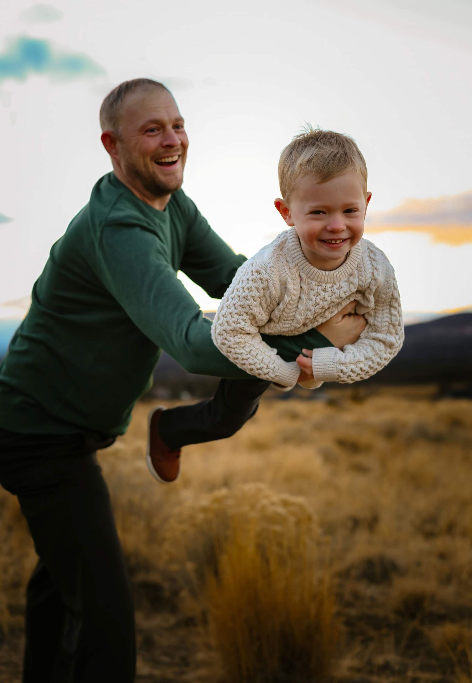 A joyful moment captured in a series of photos showing someone being swung and lifted in the desert at dusk.