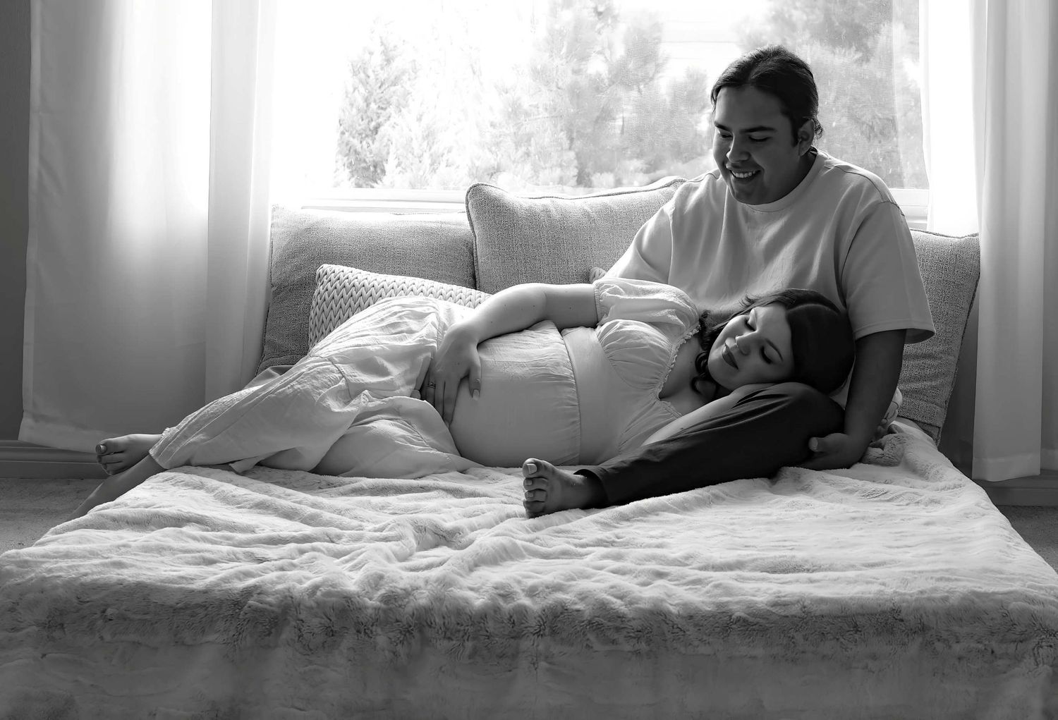 Black and white series of intimate moments showing a couple relaxing together in bed.
