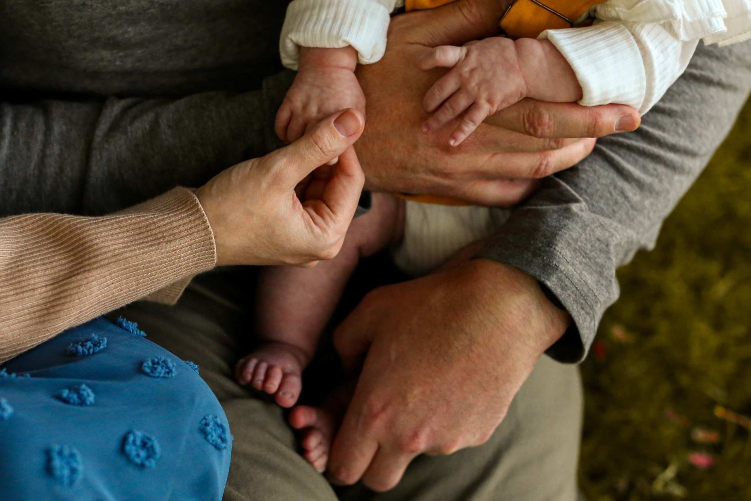 Close-up view of hands gently massaging a person's leg during a therapeutic treatment session. Hollinshead Park, Bend Oregon