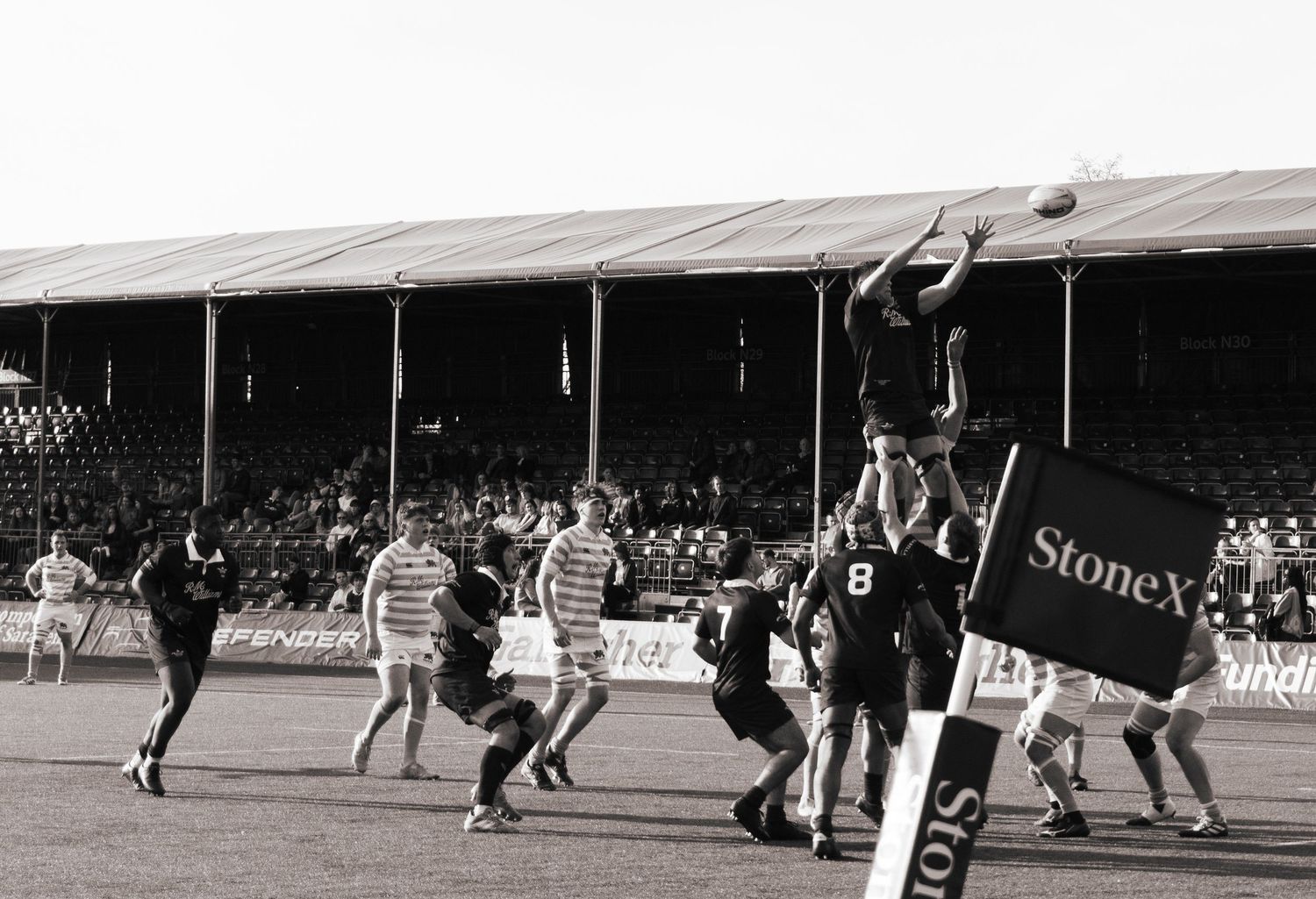 black and white photo of rugby player catching the ball in the line-up at the StoneX Stadium, North London