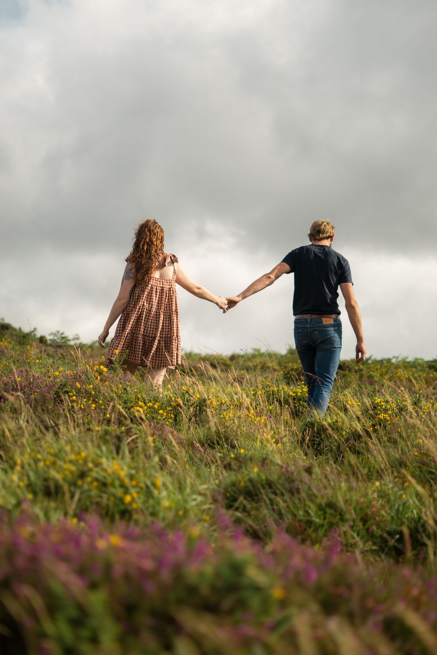 A couple walking hand-in-hand at Dartmoor National Park, Devon, England.