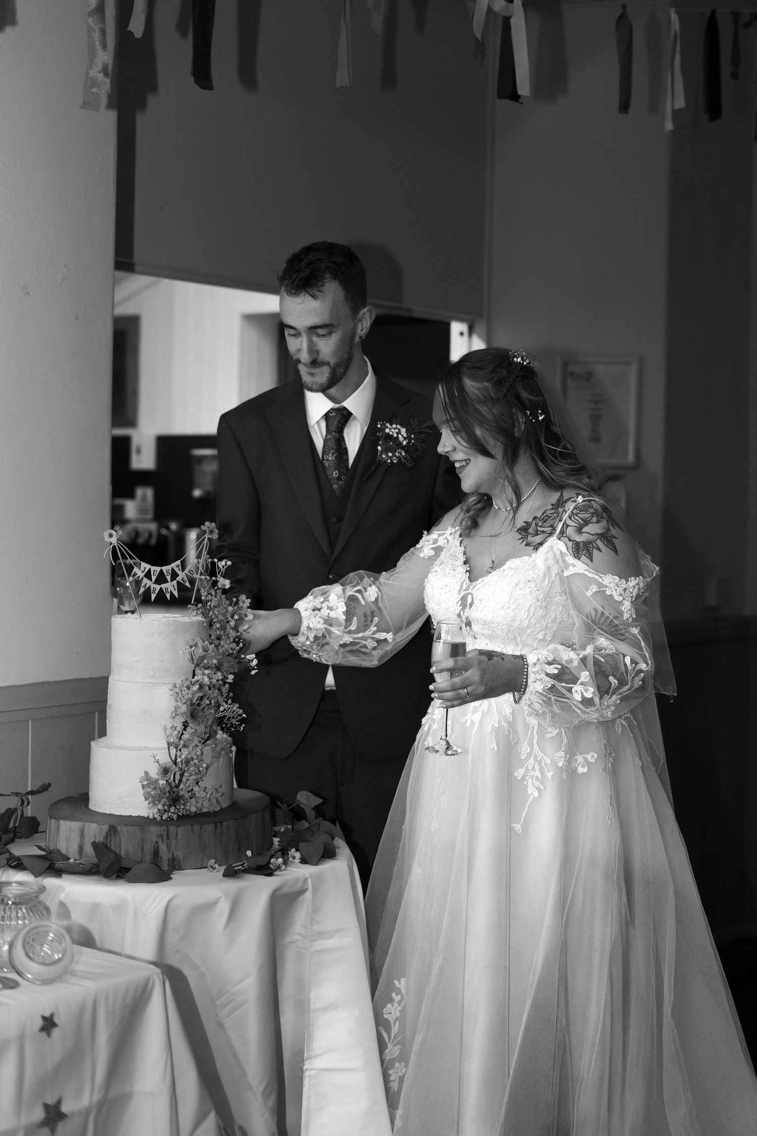 The bride and groom cutting the cake at their wedding reception in Berrynarbor, North Devon.