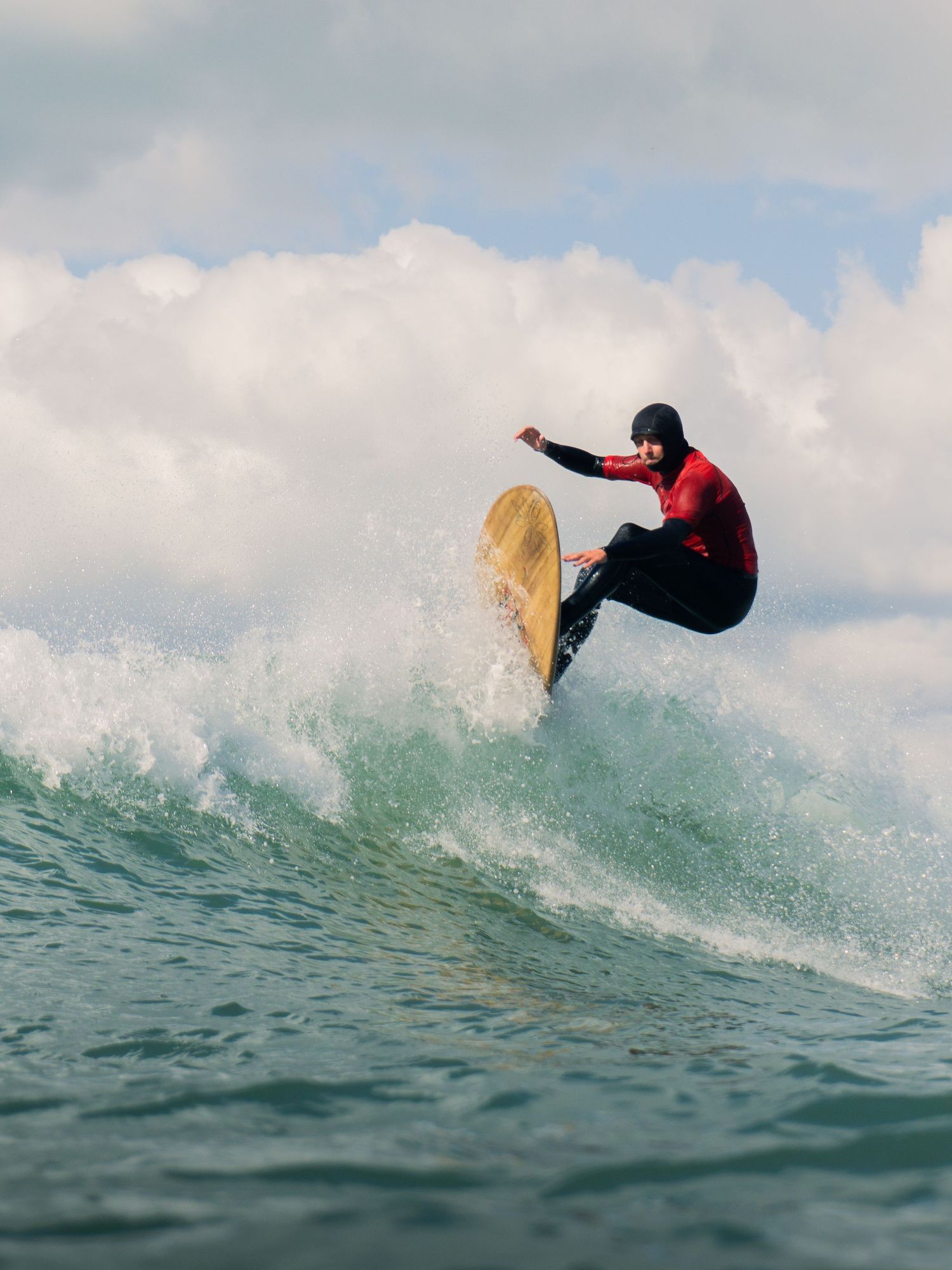 An in-water photo of Bantham Board Rider's surf competition, Devon. The surfer hits the lip