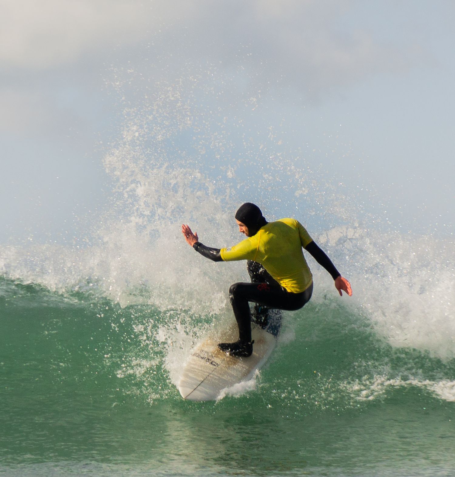 A surfer completing a top turn during Bantham Board Rider's surf competition, Devon.