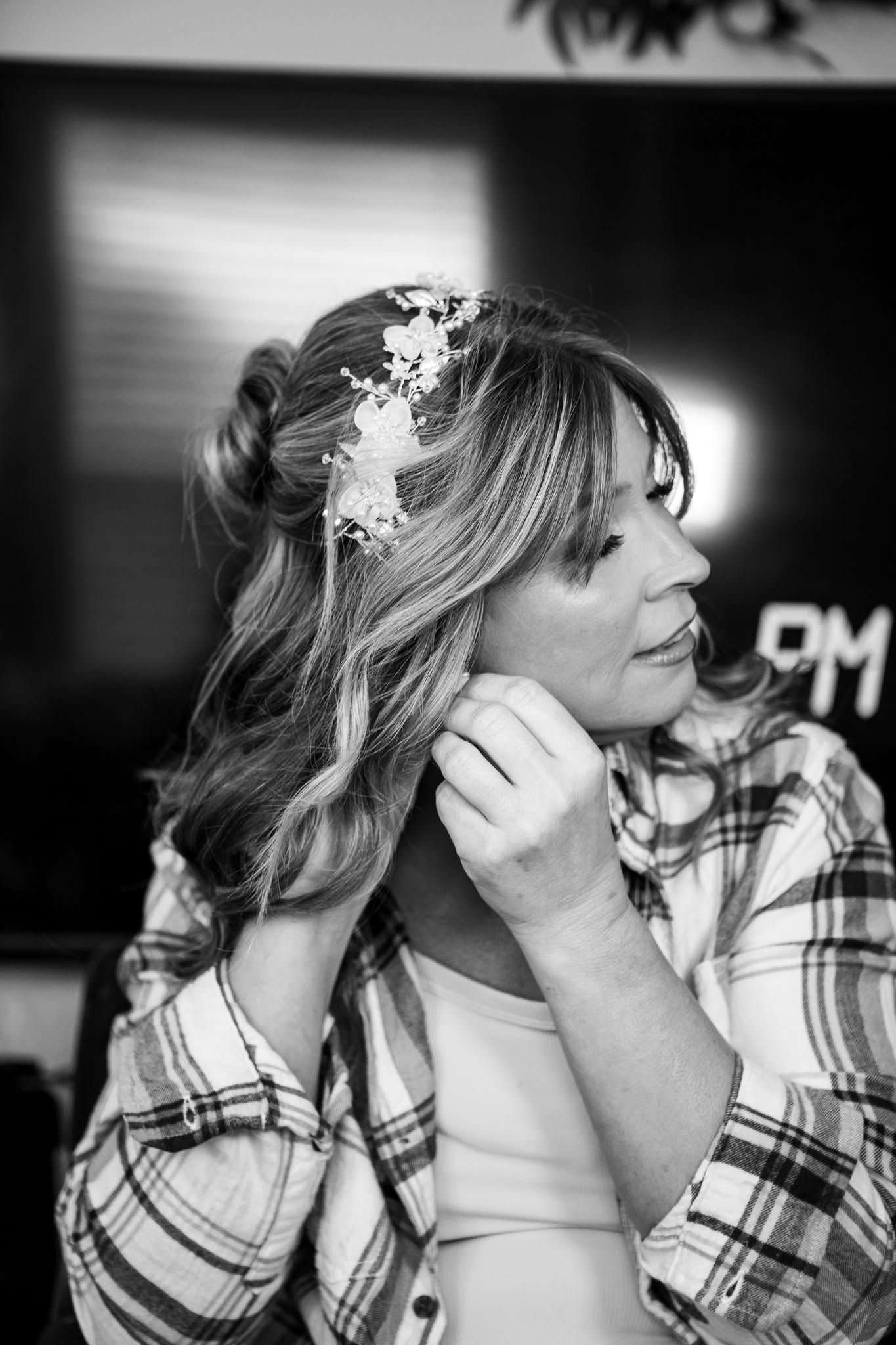 Black and white portrait with delicate hair accessories and soft lighting.