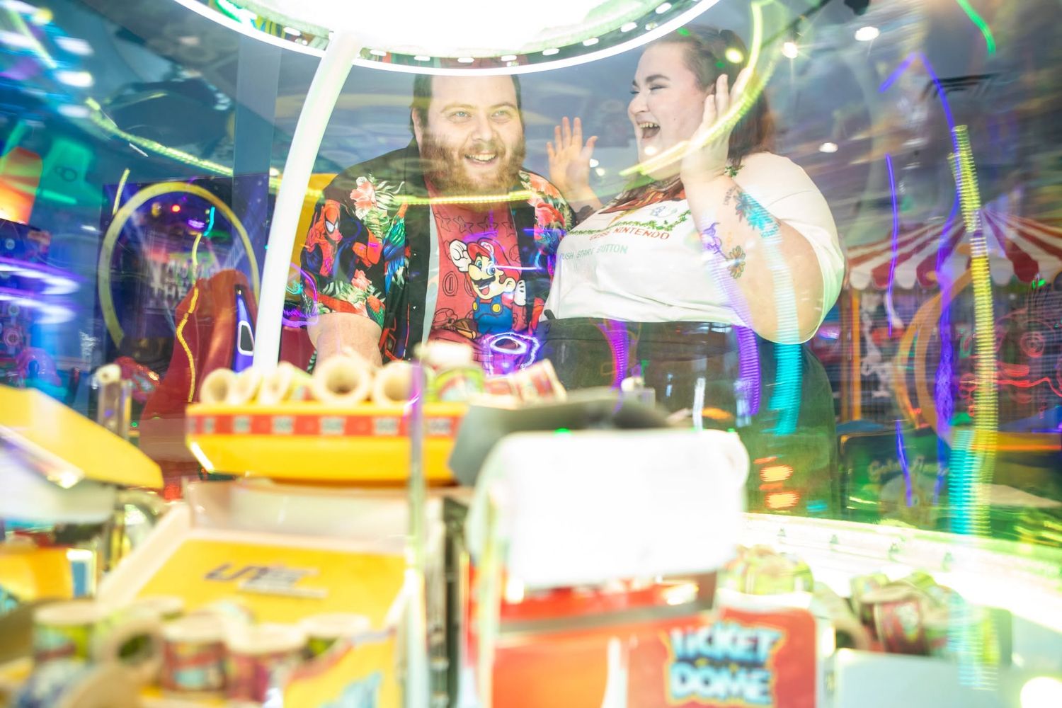 A playful arcade scene with reflections and colorful lights creating a festive atmosphere.