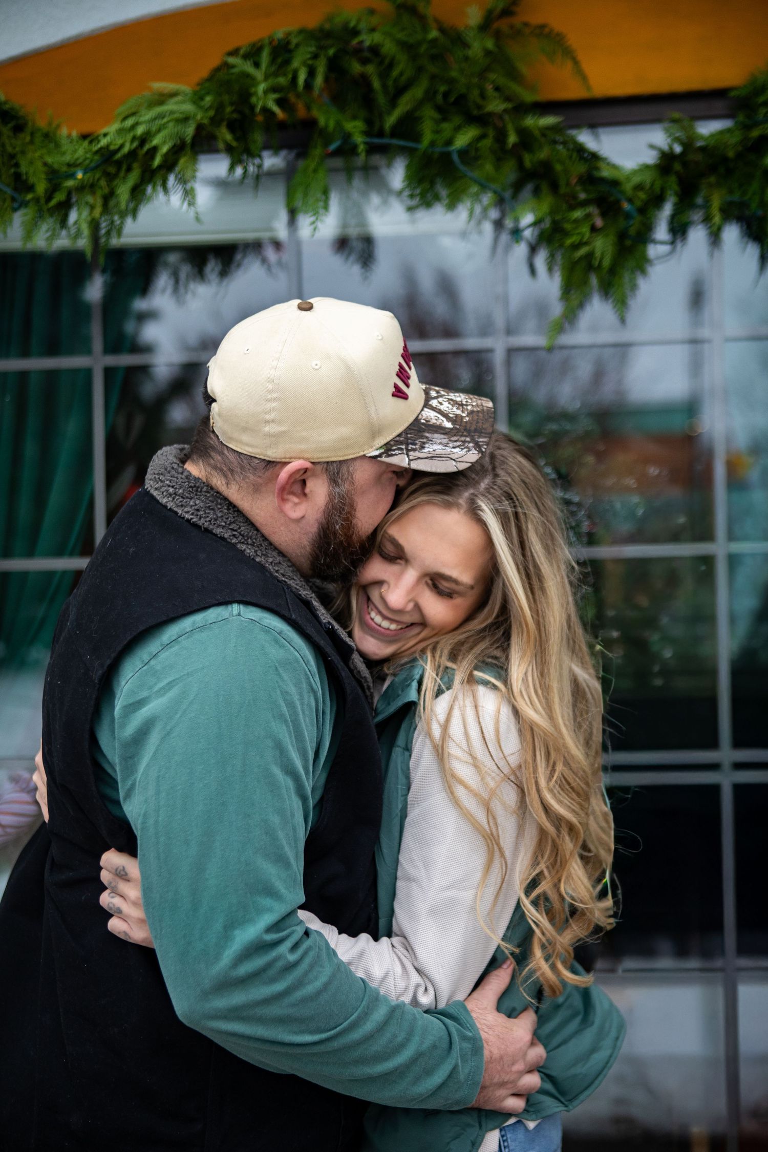 A couple shares tender embraces and romantic moments in a series of candid outdoor photos.