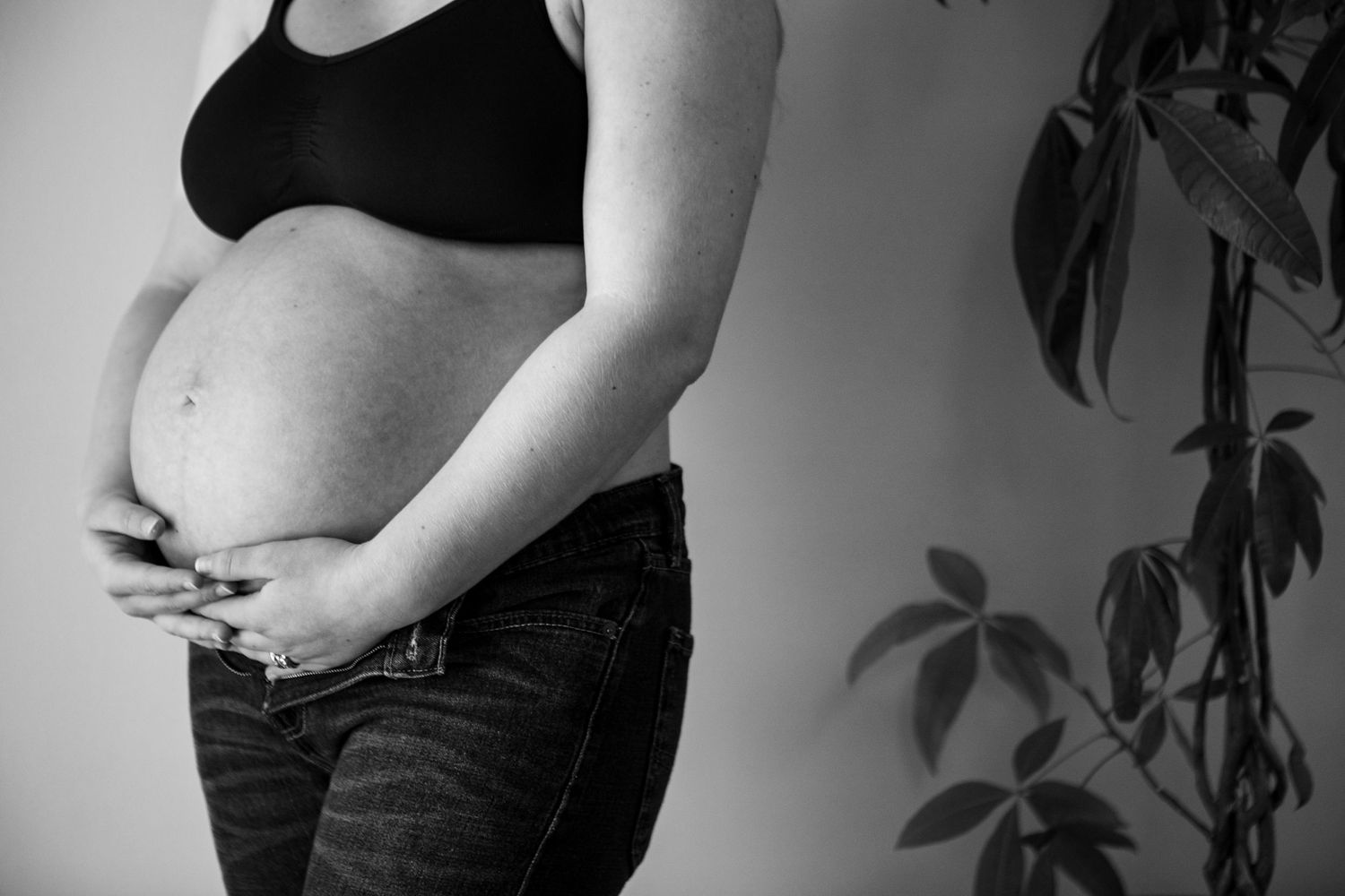 Series of artistic black and white pregnancy progression photos.