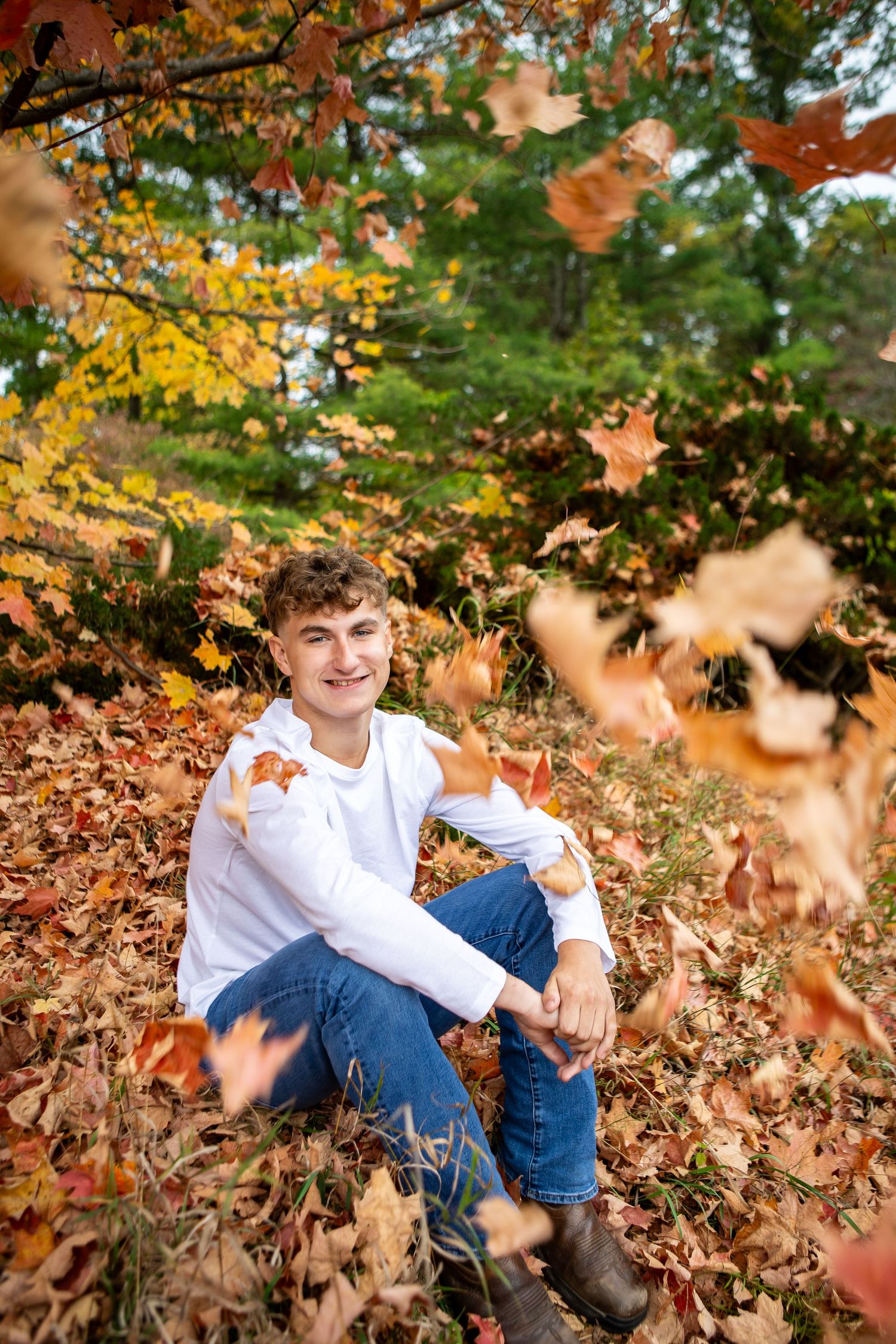A series of autumn portraits showing someone sitting among colorful fallen leaves and foliage in an outdoor setting.